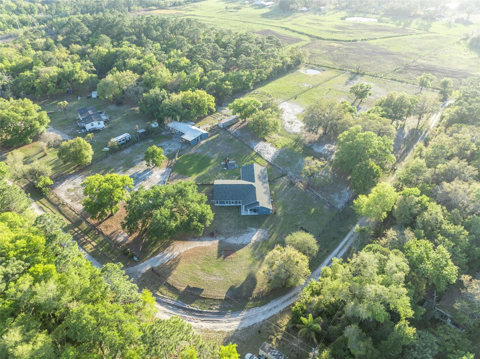 Country roads, open skies, and room to breathe… welcome home to your private Geneva retreat. Tucked away on over 5 acres along a quiet country road, this beautifully updated property blends the peaceful charm of rural living with the functionality today’s acreage buyers are searching for. Whether you envision horses, multi-generational living, a hobby farm, or simply a place to escape the city and spread out, this property delivers.

Thoughtfully enhanced in 2024, the home now offers 6 bedrooms, including a private in-law suite with its own entrance and full bath—ideal for extended family, guests, or flexible living arrangements. Major improvements include a new roof, septic system, drainfield, water filtration system, wood-look tile flooring throughout, and fresh interior and exterior paint.  Inside, the split floor plan offers both space and privacy, while the oversized Florida room creates a wall of windows overlooking the property—bringing the outdoors in and offering the perfect place for morning coffee, sunset views, and everyday country living.  Outside is where this Geneva property truly shines. The fully fenced acreage is ready for horses and country living, featuring a classic center-aisle barn with six stalls, including five 12x12 stalls plus a foaling stall with private paddock, wash and grooming area, tack and feed room, fans, and matted stalls. Multiple fenced paddocks and open pasture space provide room to roam. Towering oaks, open green space, and peaceful surroundings complete the setting.  Bring your horses, your toys, your animals, and your dreams—because life simply moves a little slower down country roads.