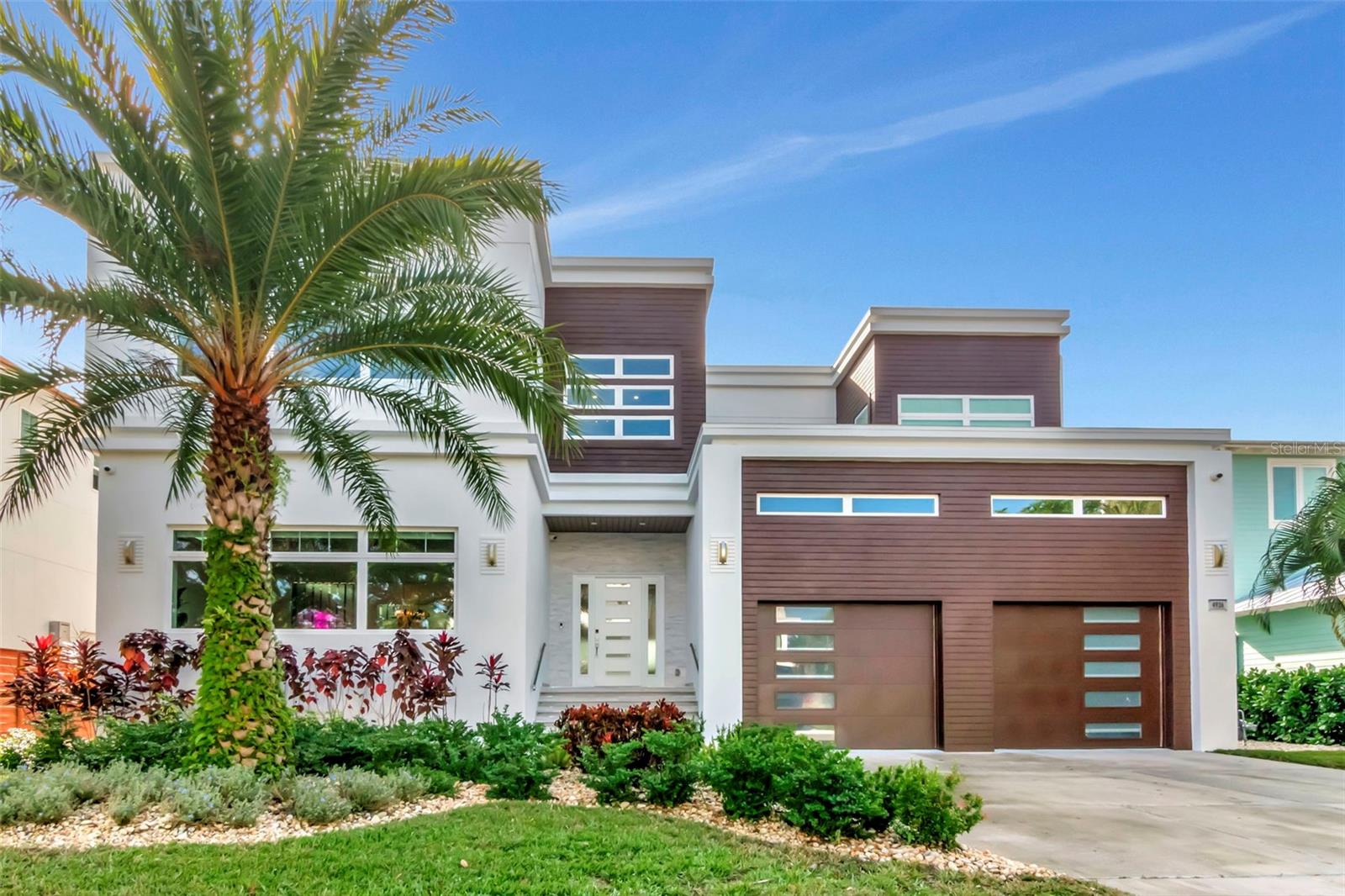 Under contract-accepting backup offers. This one-of-a-kind waterfront retreat in South Tampa offers the ultimate blend of modern luxury and thoughtful accessibility. Situated on a .23-acre cul-de-sac lot, this custom 2-story all-block residence is built on pilings with impact windows and doors for peace of mind.
Step inside to an airy, open floor plan illuminated by natural light and anchored by a specially curated Illuminati Glass chandelier featuring 89 hand-blown pieces. The chef’s kitchen is a masterpiece of Custom Italian Cabinetry, sleek quartz countertops, and professional-grade Wolf and Sub-Zero appliances.
The home’s 6,386 sq. ft. includes 5 bedrooms and 5.5 baths, where every bedroom is oversized, ensuite, and features a walk-in closet. Designed for longevity, the second floor and elevator entry from the garage make the home ADA-compliant ready. Sound-reduction insulation in the floors and walls ensures tranquility throughout.
The second floor hosts a spacious family room, a dedicated office, and four large bedrooms—including a primary suite with sweeping bay views, a spa-like bath, and a massive walk-in closet. For even grander views, the roof is structurally ready for a custom flat deck to overlook the open bay.
Outside, the Ryan Hughes-designed pool serves as a breathtaking courtyard centerpiece, featuring a sunken fire lounge, linear flame features, and a luxury outdoor kitchen under shaded pavilions. Plus, enjoy the benefits of solar energy in this high-tech, high-design masterpiece. Located on a wide canal just four lots from the open bay, this home is minutes from International Plaza and the Tampa International Airport.