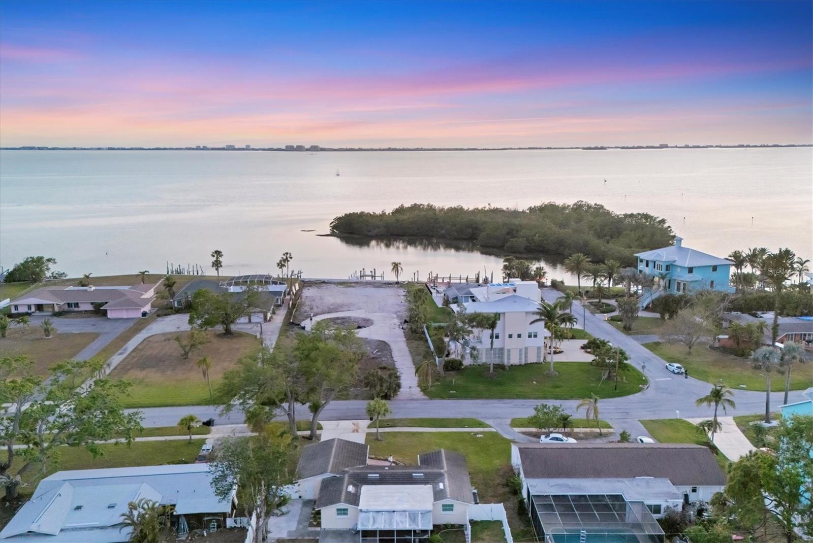 Spectacular Sarasota Bay Front Lot! 
Seize this rare opportunity to build your dream home on this .76 acre estate sized lot on the breathtaking shores of Sarasota Bay.  Construct your waterfront masterpiece in the highly sought-after historic Whitfield Estates neighborhood known for its mature trees and diverse architectural style homes. This cleared and buildable lot offers boatable water with direct access to the intercoastal waterway and the Gulf of Mexico. Saving time and planning, this lot is already equipped with a brand new seawall, a new boat dock and two new jet ski lifts, making it a dream location for any water enthusiast.  Enjoy unobstructed sunsets and stunning evening views with the bay lit up at night, stretching straight across to Longboat Key and Sarasota.  Whitfield Estates residents can enjoy an optional $35 annual fee to join the Sarasota Bay Club's culinary membership granting exclusive access to the clubhouse for dining and social events. Golf membership is available separately at the reputable SaraBay Country Club.  Conveniently located just minutes from the Sarasota's pristine Gulf Coast beaches, Siesta Key and nightlife full of vibrant entertainment featuring the Ringling Museum of Art, The Asolo Theatre, Van Wezel Performing Arts Hall, world renowned IMG Academy, Sarasota Bradenton International Airport, St. Armand's Circle and downtown Sarasota's famous restaurants and boutique shopping.  
Don't miss this extraordinary opportunity to build your waterfront sensation in the beautiful Florida Sunshine State.