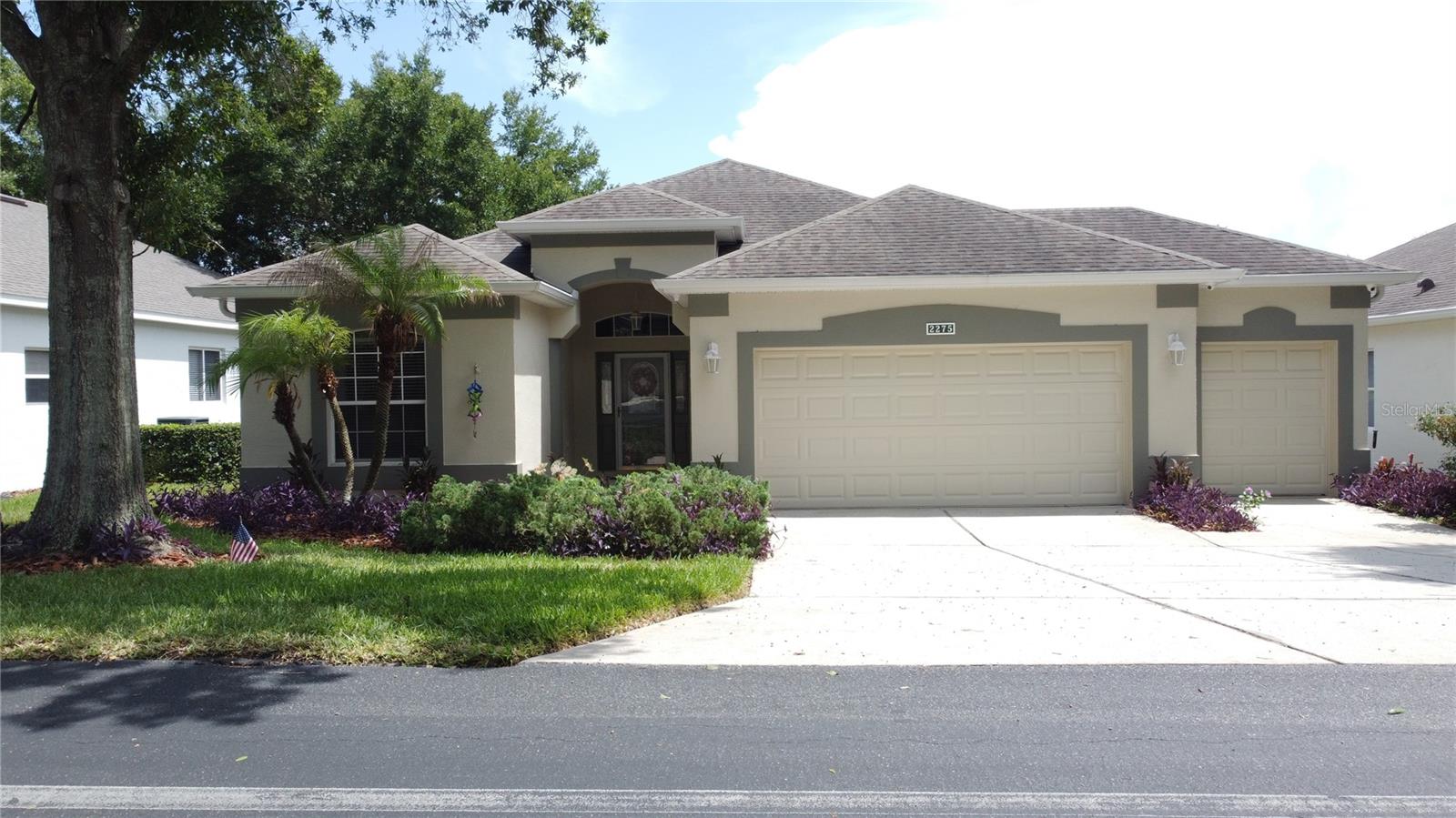 Welcome to this beautifully maintained St. Regis model in the highly sought-after, guard-gated 55+ community of Kings Ridge. Offering nearly 2,000 square feet of comfortable living space, this home features a spacious split-bedroom floor plan, a versatile den, an oversized 2.5-car garage with golf cart parking, and a bright Florida room perfect for relaxing or entertaining. Home is being sold furnished. New Roof in Dec 2014 and a new Carrier HVAC system in Aug 2020. The kitchen has Corian counter tops, wood cabinetry and ceramic tile flooring.  The dining room has new laminate flooring. The mounted TV in the bedroom will remain. Large walk in closet in the primary bedroom.  The Primary bath has a walk in shower, garden tub and private toilet area. There is a back screen enclosure as well as an enclosed lanai. The golf cart is being sold separately. Enjoy the resort-style lifestyle Kings Ridge is known for, with two championship golf courses, multiple swimming pools, tennis and pickleball courts, a state-of-the-art fitness center, clubhouse, billiards, arts and crafts, social clubs, planned activities, and countless community events. The HOA also includes cable, internet, exterior grounds maintenance, and 24-hour gated security, allowing you to enjoy low-maintenance living in one of Clermont's premier active adult communities. Conveniently located near shopping, dining, medical facilities, and major highways, this home offers the perfect blend of comfort, convenience, and an active Florida lifestyle.