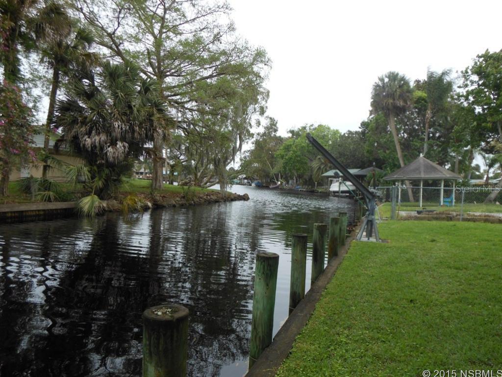 Fisherman and boaters paradise. House with seawall, Davits for your boat and only a few lots to lake area and canal to Tomoka River. When not fishing enjoy your screened pool with canal view. This three bedroom 2 bath home is lovingly cared for. Large eat in kitchen, LR with fireplace plus a  windowed Florida room to watch TV. Sit on the front porch and enjoy the sun set.