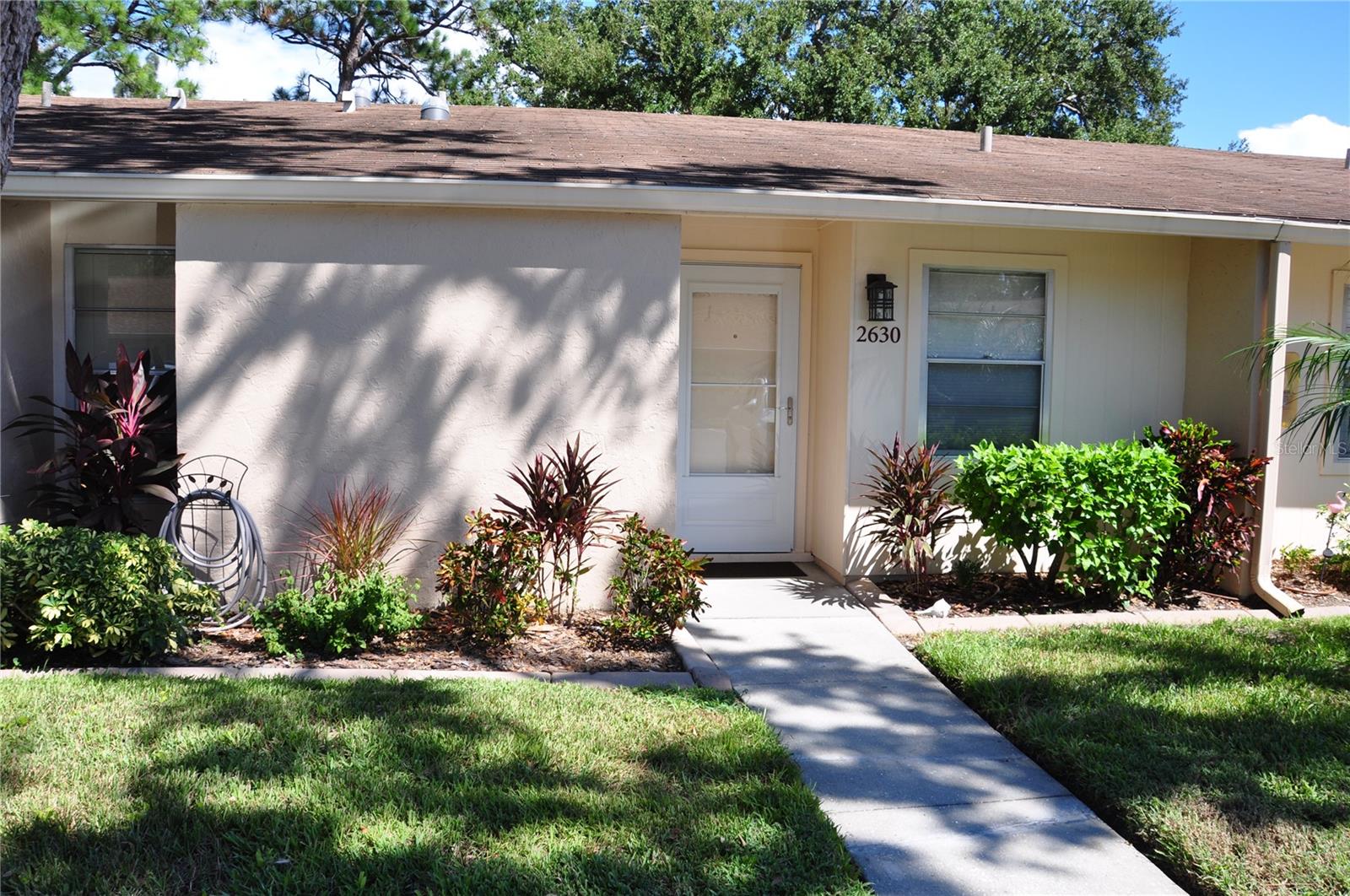 $$ 10,000.00 in closing cost's paid for by the SELLER. Like new and upgraded gorgeous condo. Minutes from world famous Siesta Key Beach and safely located in flood zone X. All new vinyl plank flooring in living areas and new carpet in bedrooms. Both bathrooms are newly renovated, freshly painted inside and out, along with a total  makeover of the kitchen in 2025. Located in the rear of the development this condo is very quiet and secure. New washer and dryer, make this as good as a new unit. Ceiling fans and skylights keep it light and bright inside. Community heated pool and fitness center are open to the residents at their leisure. Clubhouse includes kitchen, fitness center, pool table and rest rooms with showers. Lanai features fully enclosed glass windows with screens, new storm doors front and rear. Gardener's paradise in the rear with lush tropical plants. In front enjoy your reserved private parking spot. Close to shopping and some of the best restaurants in Sarasota.