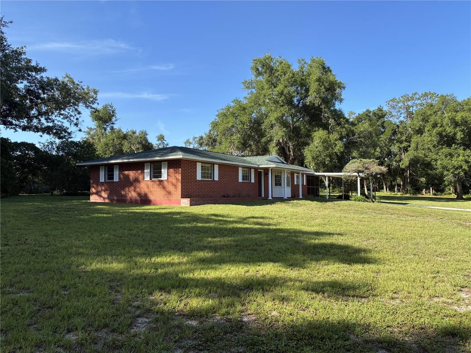 This home is located on a 2+ acre--- totally fenced parcel and is the only home in the neighborhood with that much land. The home is "dated" and could use an interior makeover. The roof was replaced in 2020 has architectural shingles. The air conditioning system was replaced around 2020. Besides a large, fenced yard this property included two outbuildings including a large barn that could serve as storage for a boat or large RV. The property is selling "as is."