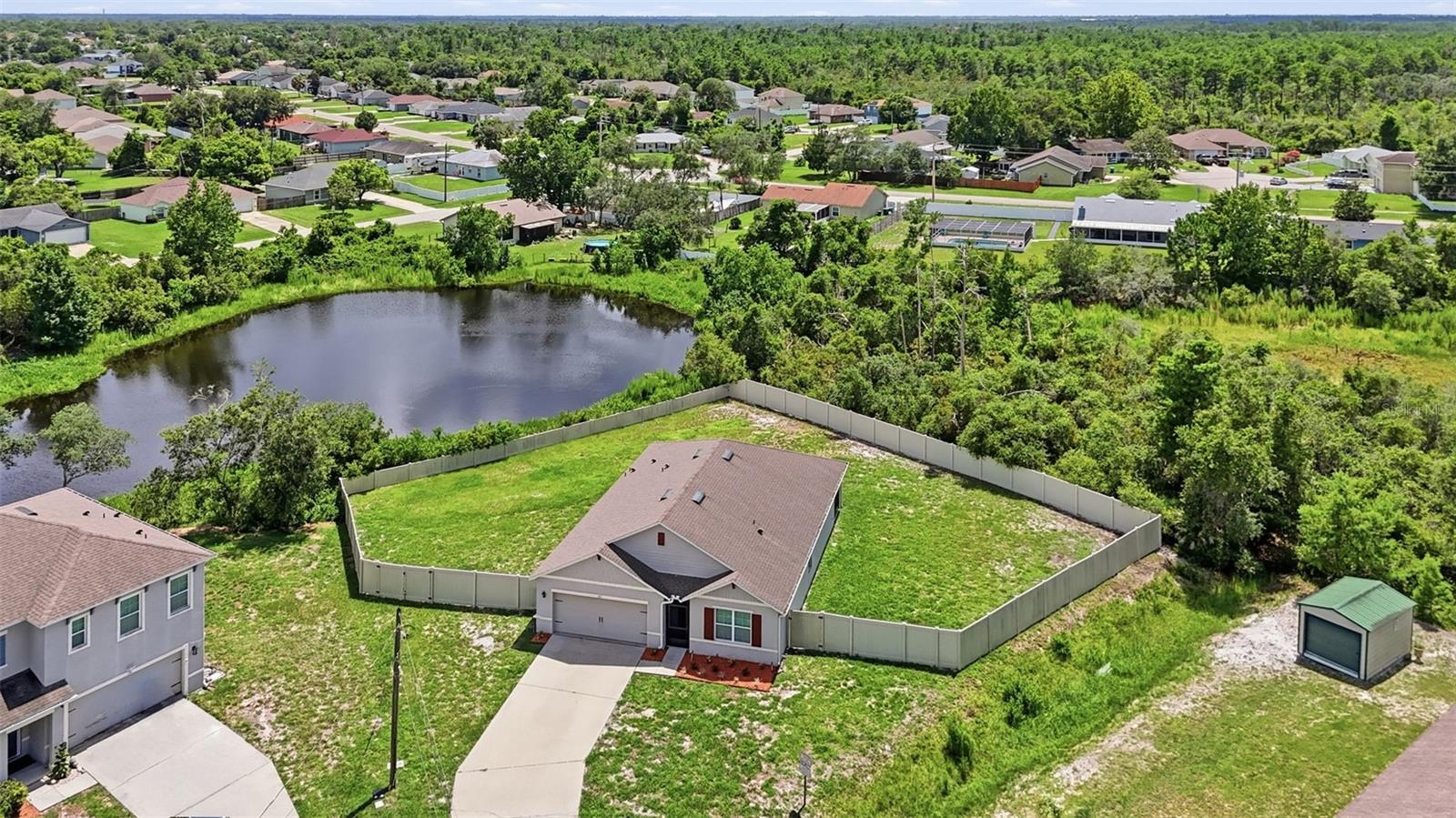 Virtually Staged. Discover the perfect blend of privacy, space, and modern comfort! Perfectly positioned on a premium .41-acre cul-de-sac lot overlooking a tranquil pond, this beautifully upgraded DR Horton Cali 4 bedroom, 2 bath 1856 sq ft model offers a rare combination of peaceful living and everyday convenience. With no rear neighbors, no HOA, and an oversized homesite that's hard to find in Deltona, this property truly stands out from the rest. From the serene water views to the thoughtful owner upgrades, every detail has been designed to make this home as functional as it is inviting.

Designed with a popular tri-split floor plan, this home provides privacy and functionality for the whole family. The spacious kitchen is the heart of the home, featuring granite countertops, a large center island with built-in sink and breakfast bar, stainless steel appliances, a walk-in pantry, and a custom coffee bar with additional cabinetry for extra storage. The open-concept living and dining areas showcase serene pond views, creating the perfect setting for everyday living and entertaining.

The generous primary suite offers a large walk-in closet and an en-suite bath with dual vanities and a spacious shower. Ceramic tile flooring flows throughout the kitchen, dining, and living areas, while the inside laundry room includes the washer, dryer, and built-in storage cabinets.

Step outside to the screened lanai, an upgrade added by the owner, and enjoy the fully vinyl-fenced backyard, another valuable owner enhancement. The expansive lot provides plenty of room to play, entertain, garden, or even add a pool—space that's hard to find in Deltona.

Stainless steel kitchen appliances, washer, and dryer conveying, and the ability to close quickly, this home is truly move-in ready. Conveniently located just minutes from I-4, providing easy access to Orlando, Daytona Beach, shopping, restaurants, medical facilities, and more.

This is your opportunity to own a beautifully maintained home on an exceptional oversized lot with peaceful water views and no rear neighbors. Schedule your private showing today!