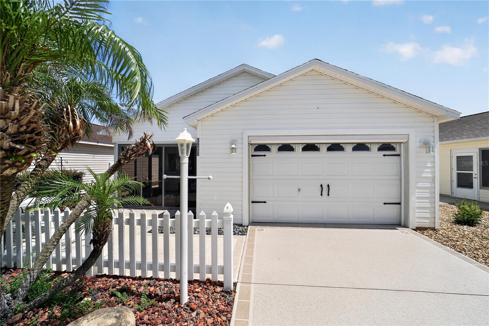 Look for the prettiest landscaping in the Hallandale Villas in the Village of St. Charles, just a few blocks to the large Seabreeze Rec Center. This 2/2 Colony patio villa is being sold Turnkey and includes a gas Yamaha golf cart (AS-IS). As you drive up, you will notice behind the beautiful landscaping is a patio with table and chairs and a side patio with a grill. Enter through the glass door to the glass enclosed lanai with shades, furniture and a beautiful picture-like window. Enter through the leaded glass front door and you will see luxury vinyl flooring throughout. The vaulted knockdown ceilings and open floor plan make this home spacious. The dining room has a table with a leaf, 6 chairs and a buffet. The living room has a brand new sofa, love seat, 2 end tables with lamps, TV with console and a cocktail table. The kitchen has granite countertops, nice backsplash, stainless appliances and a lovely rolling cabinet for extra storage. The laundry is in the kitchen area next to the pantry. There is a solar tube for natural lighting. The primary bedroom currently has 2 full size beds, a chest, dresser and 2 nightstands. There is a large walk-in closet and ceiling fan. The guest bedroom has a brand new king size bed with a chest, dresser, nightstand and lamp. There is also a built-in closet and ceiling fan. The primary bathroom has a step-in shower and the guest bathroom has a tub/shower combination. There is a linen closet in the hallway for extra storage. The garage is a 1.5 car garage with room for car and a golf cart. This is where you will find the Yamaha gas golf cart which is included. This home is located close to several pools and perfect home for an investment. Roof 2015, HVAC 2017 and water heater is original. Taxes $1,313.35, Fire $320.71, Maintenance $318.26 and BOND IS PAID!