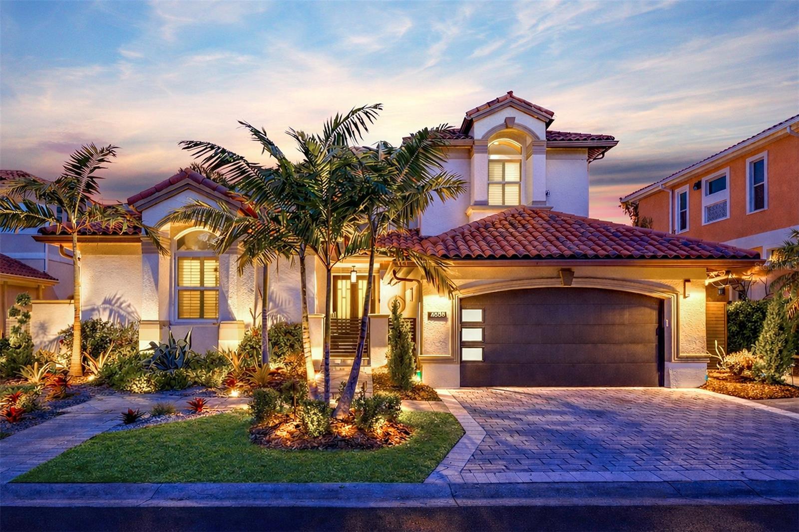 Experience an unparalleled waterfront lifestyle in this exquisite single-family home, perfectly situated at 4635 Dolphin Cay Ln S in St Petersburg. Boasting a coveted high elevation, this residence offers breathtaking, panoramic views of Boca Ciega Bay from nearly every vantage point, creating a serene and picturesque backdrop for everyday living.

Step inside and discover an open-concept design accentuated by soaring 12-foot ceilings and pristine white oak hardwood flooring that flows seamlessly throughout. The heart of this home is undoubtedly the chef's dream kitchen, featuring top-of-the-line professional Heston appliances, stunning granite and stone countertops, and a double island perfect for entertaining. Culinary enthusiasts will delight in the double dishwasher, gas cooktop grill, three ovens, and a custom gold range hood, all complemented by an elegant pebble stone backsplash and a charming eat-in dining area.

The expansive living room invites relaxation with its elegant wet bar and a captivating double-sided glass fireplace, offering warmth and ambiance. Enjoy tranquil pool views that blend effortlessly with the sparkling bay. The main level also thoughtfully includes a dedicated office space and a comfortable guest bedroom, ensuring convenience and privacy.

Ascend to the luxurious primary suite, a true sanctuary featuring mesmerizing water views, a private sitting area, and an exclusive balcony perfect for savoring morning coffee or evening sunsets. The opulent primary bath is an indulgent retreat, complete with a freestanding soaking tub with a ceiling-mounted faucet, a spacious two-person shower with a rain shower head, two custom vanities, and a generously sized walk-in closet with cabinet lighting, plus the added convenience of a second washer and dryer. A dedicated workout room further enhances this home's exceptional offerings.

Outside, the mature tropical landscaping frames a private oasis centered around a pebble-tec, saltwater pool and spa, surrounded by multiple seating areas and a built-in grill for effortless outdoor entertaining. The private dock, equipped with a 20,000 lb boat lift, provides direct access to the sparkling waters. This guard-gated community elevates your lifestyle with exclusive access to a private beach, tennis courts, and a casino/clubhouse, all connected by scenic walking trails and much more.

Perfectly positioned, this home offers the best of St. Petersburg living, just a 10 minute drive from vibrant downtown, 10 minutes from the pristine sands of St. Pete Beach, and a convenient 30-minute drive to Tampa International Airport. This is more than a home; it's a lifestyle.

Don't miss the opportunity to own this magnificent waterfront retreat. Schedule your private showing today and begin living the dream!