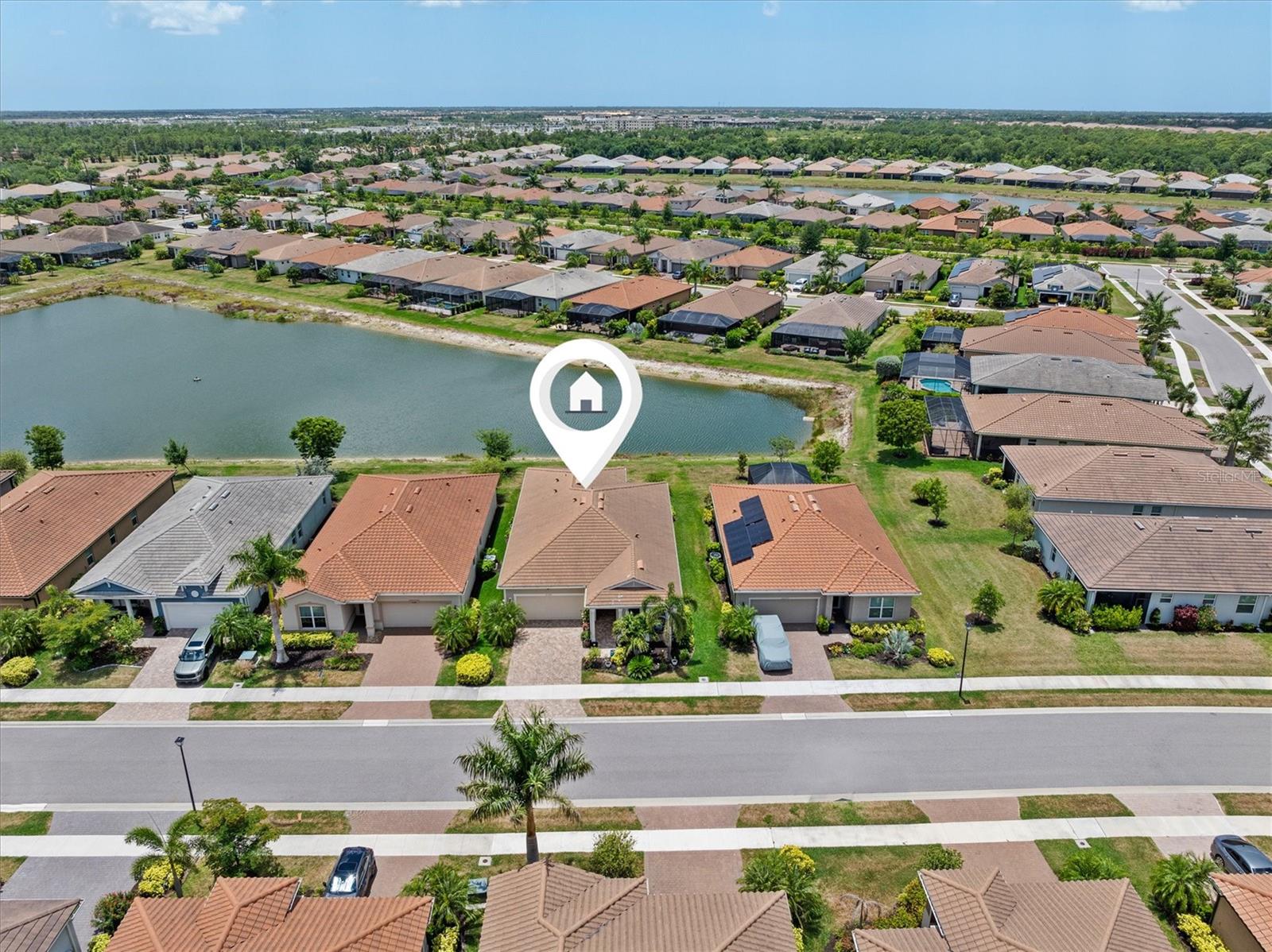 **HOA FEES PAID THROUGH 2026 • X FLOOD ZONE • 2021 BUILT • WATER VIEW LOT • GATED RESORT COMMUNITY
Sought after Renaissance at Wellen Park, where this 2021 built, 3 bedroom PLUS OFFICE/DEN home offers peaceful water views, maintenance-free living, Community Lifestyle Manager on duty and valuable owner upgrades. Situated on a premium water view lot along one of the community’s quieter streets, this residence provides added value with HOA fees paid through 2026 and an X Flood Zone location. The thoughtfully designed split floor plan offers privacy for owners and guests while the versatile den provides ideal space for a home office, hobby room, or additional flex space.
Extra-wide ceramic tile plank flooring leads throughout bright open living areas designed for everyday living and entertaining. The great room features 9.5-foot ceilings, 8-foot doors, and an 8-foot triple-panel sliding glass door, maximizing natural light and showcasing water views. Enjoy peaceful sunrises from the front porch and relaxing sunsets from the screened lanai overlooking the water.
The kitchen offers quartz countertops, stainless steel appliances, walk-in pantry, and an expansive 7.5-foot center island, creating functional space for cooking and gathering. Additional interior upgrades include 2-inch Levolor blinds, retractable front door screen, and professionally painted accent walls, including the primary suite featuring HGTV by Sherwin Williams 2025 Color of the Year “Quietude.”
The primary suite includes an oversized walk-in shower, dual vanity with quartz countertops, and an extra-large walk-in closet. Additional owner improvements include whole house water softener and filtration system, hurricane shutters, whole house gutters, screened lanai, and two overhead garage storage racks.
Residents enjoy private access to resort-style amenities including swimming pool with lap lanes, fitness center, tennis courts, pickleball courts, bocce ball, playground, clubhouse, gated entry, and year-round social activities, with lawn maintenance included.
Conveniently located approximately 1.5 miles to Downtown Wellen, 12 miles to Gulf Coast beaches, and 6.5 miles to I-75, providing easy access to shopping, dining, entertainment, recreation, and travel.
Whether seeking a full-time residence, seasonal retreat, or low-maintenance Florida home, this property offers modern construction, water views, flexible living space, and access to one of Venice’s most desirable communities.