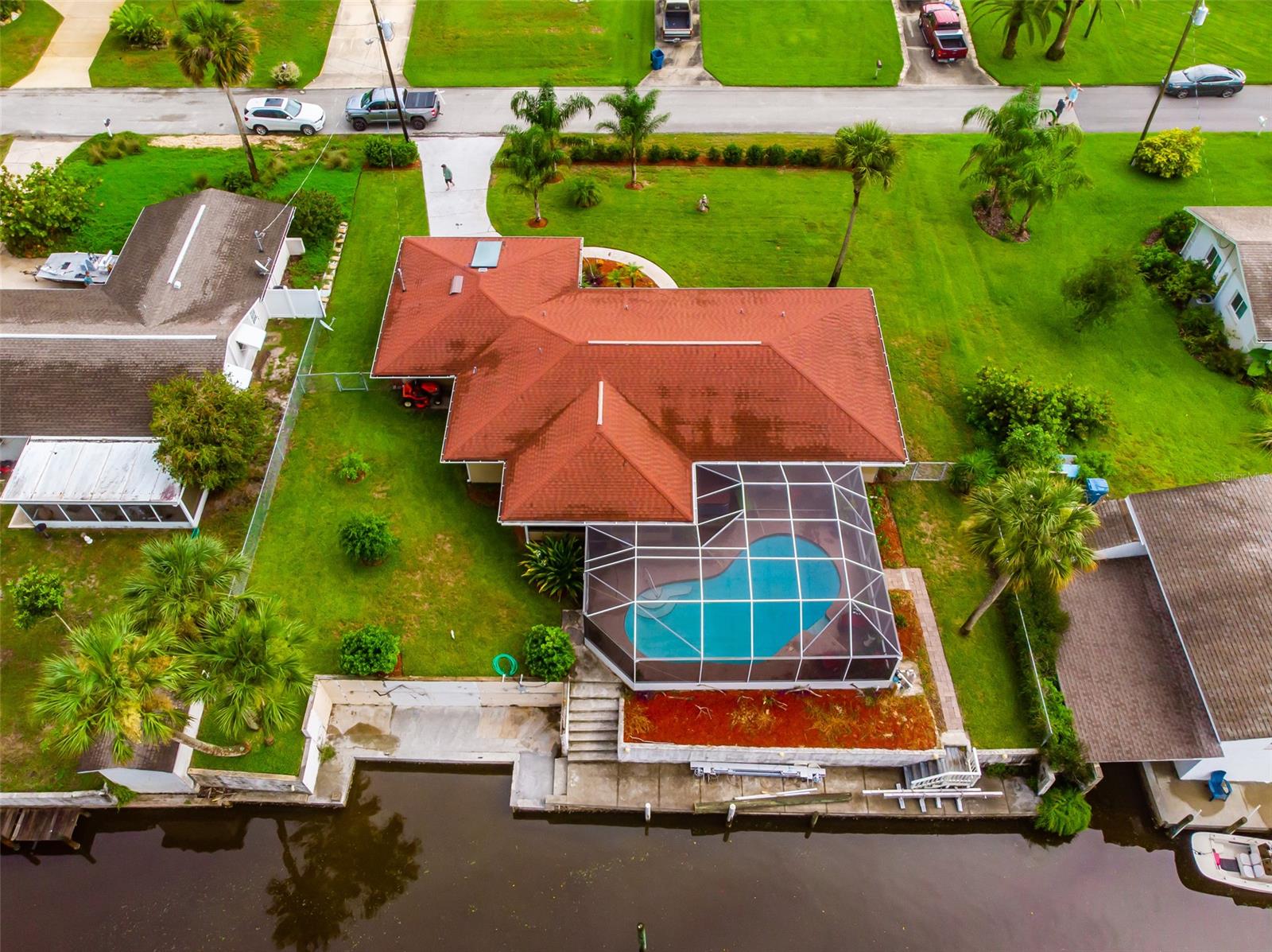 This beautiful waterfront home is on 100 feet of deep water just minutes from the Intracoastal Waterway and recently reduced! This WATERFRONT home is PRICED TO SELL!  Open floor plan home with kitchen, dining & living combination. Granite countertops, Stainless appliances,  newer  roof & crown molding throughout. The seller is installing 13,000 pound Boat Lift prior to sale. The swimming pool is newly screened in. Garage is over sized 2 car with a drive through & is equipped with half bath. Indoor laundry room, & under air enclosed Florida room perfect for gathering or home office. Recessed lighting throughout with lots of windows providing natural light. Plenty of wildlife live in your future backyard - Manatees, Redfish, Snook & Dolphin. Concrete Seawall & Dockage for several boats. Schedule your showing today & start living the waterfront life! ;Water: City