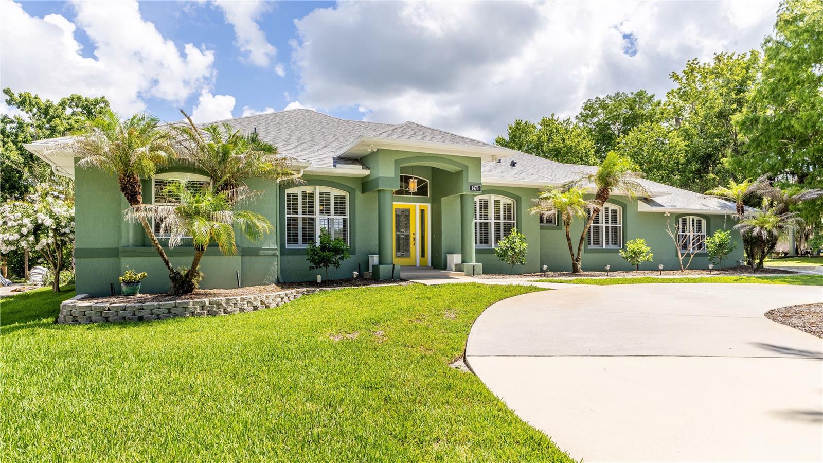 Welcome to your dream waterfront retreat in the highly sought-after Stone Island community! This stunning four-bedroom, three-bathroom home offers the perfect combination of luxury, comfort, and peaceful waterfront living. Nestled along a tranquil canal with direct access to Lake Monroe and the renowned St. Johns River chain of lakes, this exceptional property is a paradise for boating, fishing, and enjoying Florida's natural beauty. Step outside to an impressive, oversized boat dock featuring a boat lift and an expansive covered lounge area – the perfect place to entertain guests, relax with family, or cast a fishing line right from your own backyard. Inside, the home is filled with abundant natural light, creating a bright and welcoming atmosphere throughout. Decorative plantation shutters accent every window, while custom exterior French doors with built-in blinds between the double-paned glass offer both elegance and convenience. Beautiful, large-format tile flooring flows throughout the main living areas, complementing the home's open and spacious design. The enormous primary suite is a true sanctuary, highlighted by a beautiful bay window overlooking the backyard and waterfront, along with a luxurious en-suite bathroom featuring dual vanities and a relaxing Jacuzzi-style soaking tub. A separate secondary bedroom suite with its own private bathroom provides the perfect setup for guests or multi-generational living. The kitchen is designed to impress, boasting stainless steel appliances, a professional gas cooktop, built-in oven with microwave above, French-door refrigerator, gorgeous stone countertops, and a spacious center island ideal for meal preparation and entertaining. Outside, the meticulously maintained yard showcases freshly planted fruit trees, decorative landscaping, and lush greenery, while a large wood-framed storage shed provides abundant space for tools, lawn equipment, and outdoor gear. Additional highlights include a massive air conditioning system and a roof replaced in 2019, providing peace of mind for years to come. Stone Island is one of Central Florida's hidden gems, offering a truly unique lifestyle surrounded by nature and wildlife. Private winding roads weave beneath magnificent century-old oak trees draped in Spanish moss, creating an atmosphere of privacy, serenity, and timeless charm. Residents enjoy exclusive amenities including horse stables, tennis courts, a private boat ramp, and a pavilion and playground area perfect for family gatherings and community events. Golf carts are welcome on the quaint community roads, adding to the neighborhood's unique charm. Despite its secluded setting, Stone Island is conveniently located just minutes from I-4, shopping, dining, and everyday conveniences. Don't miss this rare opportunity to own an extraordinary waterfront home in one of Central Florida's most beautiful and distinctive communities – one that beautifully blends nature with charm and comfort!