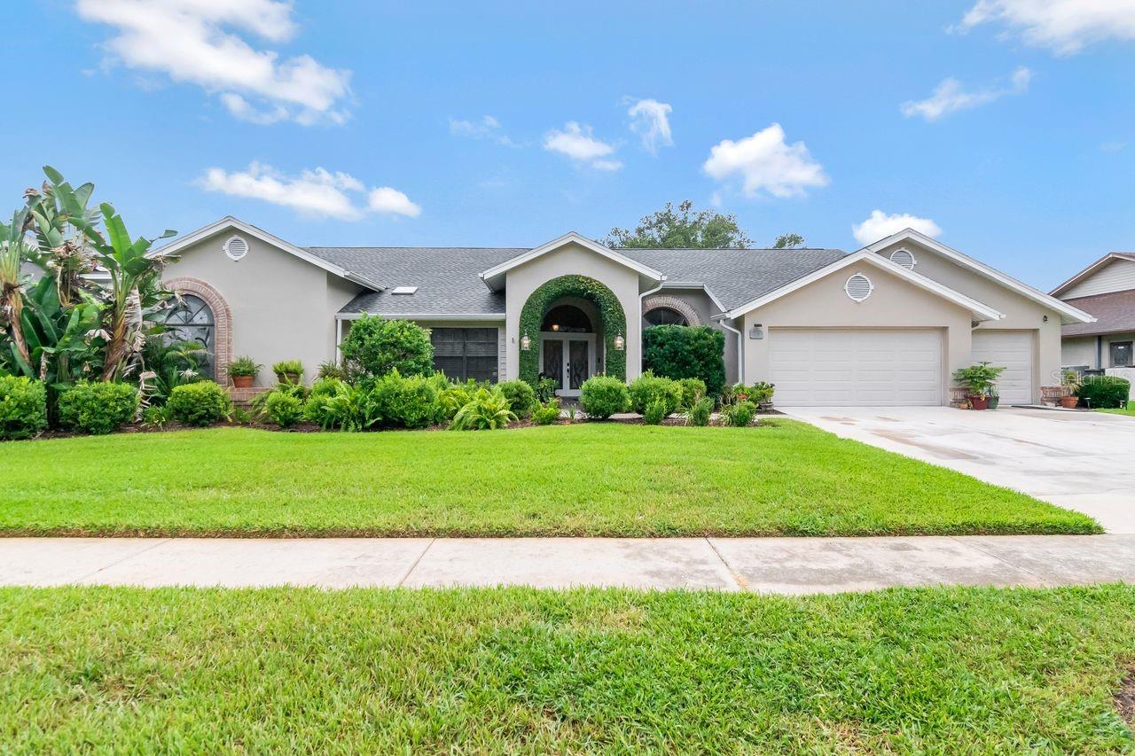 Welcome to this exceptional residence in the highly coveted Hamlet Subdivision, where mature palms, manicured landscaping, and wide peaceful streets create an atmosphere of timeless elegance.  This beautifully appointed 5 Bedroom,3 Bath, 3-CarGarage Pool Home sits on a lush 100 x 150 private fenced lot.  A tile walkway leads to double leaded-glass doors, opening into a warm foyer with rich hardwood floors. Designed for both entertaining and everyday comfort the formal Living Room and Dining Room feature dramatic cathedral ceilings and sliders that open to the lanai and pool.  Located just off the elegant Primary Suite, this private room is ideal for a home office, nursery or 5th Bedroom/flex space.  Your spacious Primary ensuite offers lanai and pool access, huge walk-in closet, dual marble vanities plus a separate dressing area, relaxing garden tub, separate shower and private water closet with bidet.  The gourmet Kitchen includes granite counters, wood cabinetry with rope trim, island with double sinks, skylight, tile backsplash, and a large dinette overlooking the pool.  The inviting Family Room is Perfect cozy evenings or lively gatherings offering a charming brick wood-burning fireplace, built-in shelving and direct access to the outdoor living areas. Step outside to your private Florida oasis.  Two expansive covered lanai's ideal for dining, lounging, or entertaining.  Fully equipped outdoor kitchen with sink and mini-fridge. Sparkling resort style pool with generous decking and lush landscaping and mature trees to create a serene, secluded backdrop.  Fantastic 3 way split plan. NOTABLE Updates & Improvements: NEW ROOF 2025, NEW A/C 2025 and 2017, 6 New Windows 2020 and POOL BATH Remodel 2021 plus so much more.  This Home has been lovingly maintained and thoughtfully improved.  A MUST SEE!