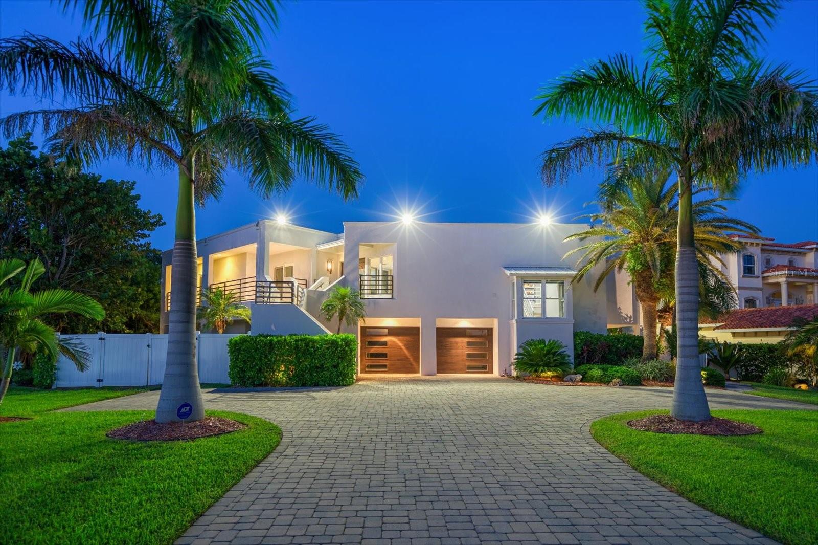 Imagine beginning each morning with the sunrise reflecting across the Intracoastal from your private balcony, spending the afternoon cruising directly from your backyard dock to the Gulf of Mexico, and ending the day with a sunset stroll along one of Florida's most exclusive white-sand beaches just steps away. Welcome to one of Belleair Beach's most coveted waterfront addresses, where luxury boating and coastal living unite in an extraordinary setting.

Perfectly positioned on one of the island's most prestigious streets, this custom Coastal Modern masterpiece offers the rare combination of protected deep-water boating with a private dock and 7,000-lb boat lift, plus effortless Gulf beach access just moments from your front door. Encompassing 7,698 square feet under roof, this exceptional residence features 4 bedrooms, 3.5 bathrooms, a 3+ car tandem garage, resort-style pool and spa, outdoor kitchen, private putting green, and thoughtfully designed indoor and outdoor living spaces.

A dramatic wrap-around balcony and grand double-door entry introduce light-filled interiors showcasing porcelain and bamboo flooring, custom woodwork, elegant built-ins, and expansive waterfront views. The open-concept design flows seamlessly into a chef's kitchen featuring granite countertops, a large center island with prep sink, three ovens, two dishwashers, stainless steel appliances, and abundant custom cabinetry—perfect for everyday living and entertaining on any scale.

The luxurious primary suite offers a private waterfront balcony, spa-inspired bath with jetted soaking tub, oversized walk-in shower, dual vanities, and an impressive custom walk-in closet. An adjacent flex room provides the ideal space for a home office, den, fitness room, or optional fifth bedroom.

Designed for entertaining, the lower level features a multimedia theater, game room, guest suite with private bath, and kitchenette, creating an ideal retreat for family and overnight guests.

Outside, enjoy your own private waterfront resort with a heated and chilled saltwater pool and spa, covered outdoor kitchen, entertaining bar with built-in fire feature, brick-paver deck, private putting green, and waterfront dock complete with power, water, and boat lift.

Recent capital improvements include a new roof (2022), upgraded Trane HVAC systems with Wi-Fi thermostats, smart security system, and additional recent infrastructure improvements, offering added peace of mind for the next owner.

Luxury is more than exceptional finishes—it's the freedom to enjoy the Florida lifestyle at its finest. Boat to the Gulf from your backyard, relax on the sugar-white sands of Belleair Beach, or enjoy nearby golf, yacht clubs, waterfront dining, tennis, pickleball, and all the attractions of Clearwater Beach. This is a rare opportunity to own one of Belleair Beach's premier waterfront residences, where every day feels like a private coastal retreat.
