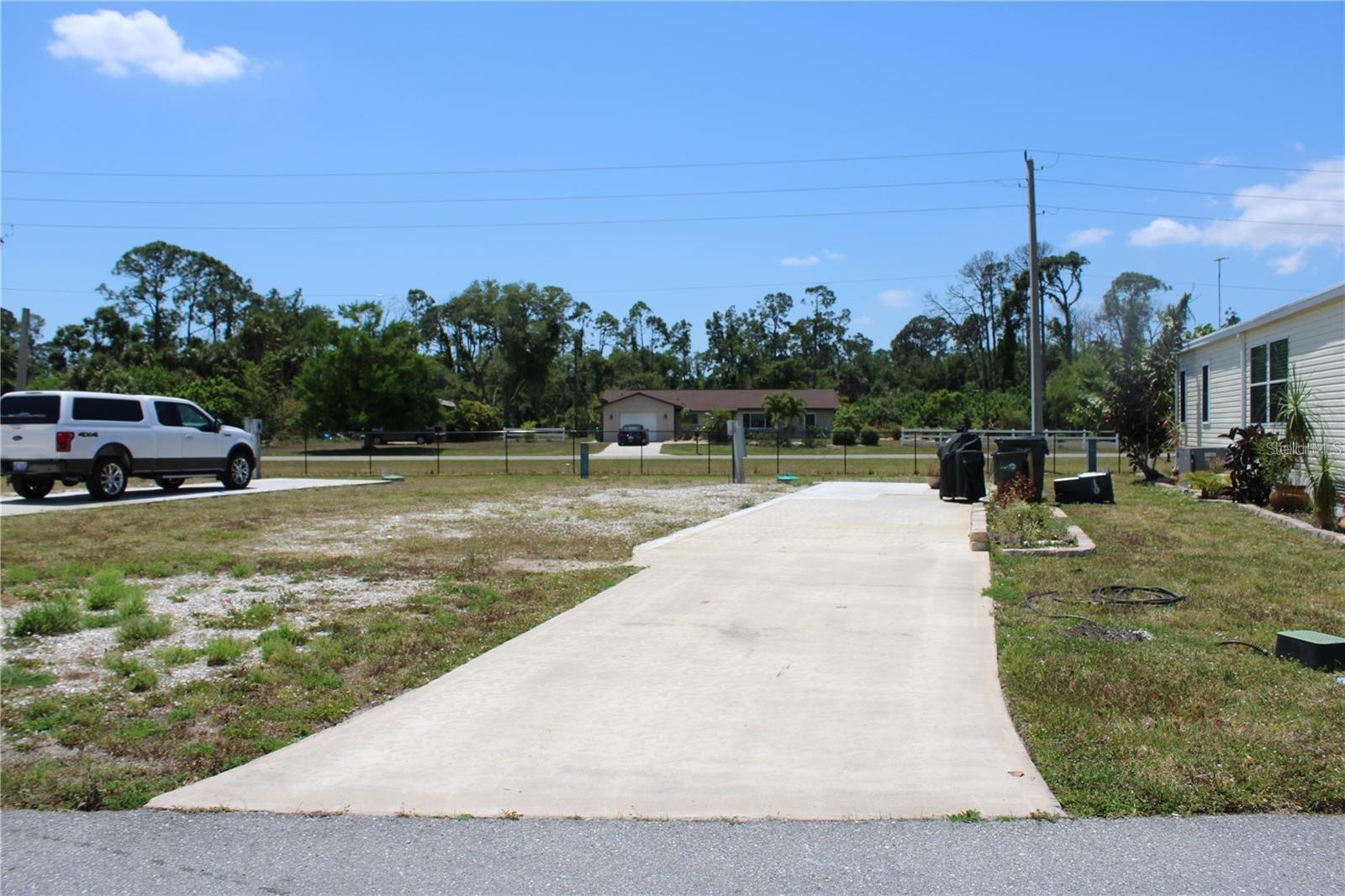 Discover an affordable Florida retreat in the highly desirable Holiday Park, a gated 55+ community where you own the land by deed—no lot rent.

Holiday Park is known for its active lifestyle and impressive recreational facilities, including two heated swimming pools, tennis courts, pickleball courts, bocce ball courts, shuffleboard courts, horseshoe pits, a fitness center, billiards room, library, card room, clubhouse, and a full calendar of social activities and events. Residents also enjoy boat and RV storage (first-come basis), community laundry facilities, lawn mowing, and garbage collection.

Take a stroll or cruise by golf cart through the beautifully maintained community grounds featuring a scenic lake and gazebo. Conveniently located near shopping, dining, medical facilities, and Southwest Florida's beautiful Gulf beaches, the home is also just minutes from the Atlanta Braves Spring Training facility, making it a great choice for baseball fans.

The annual Special District Assessment is $2,340 ($195 monthly equivalent) and is included in the property tax bill. Unlike communities with lot rent or share ownership, Holiday Park homeowners own the land their homes sit on. The assessment covers community amenities, lawn maintenance, and access to RV storage on a first-come basis. There is no HOA fee.

Don't miss this opportunity to own an affordable piece of paradise in one of North Port's most active and friendly communities.