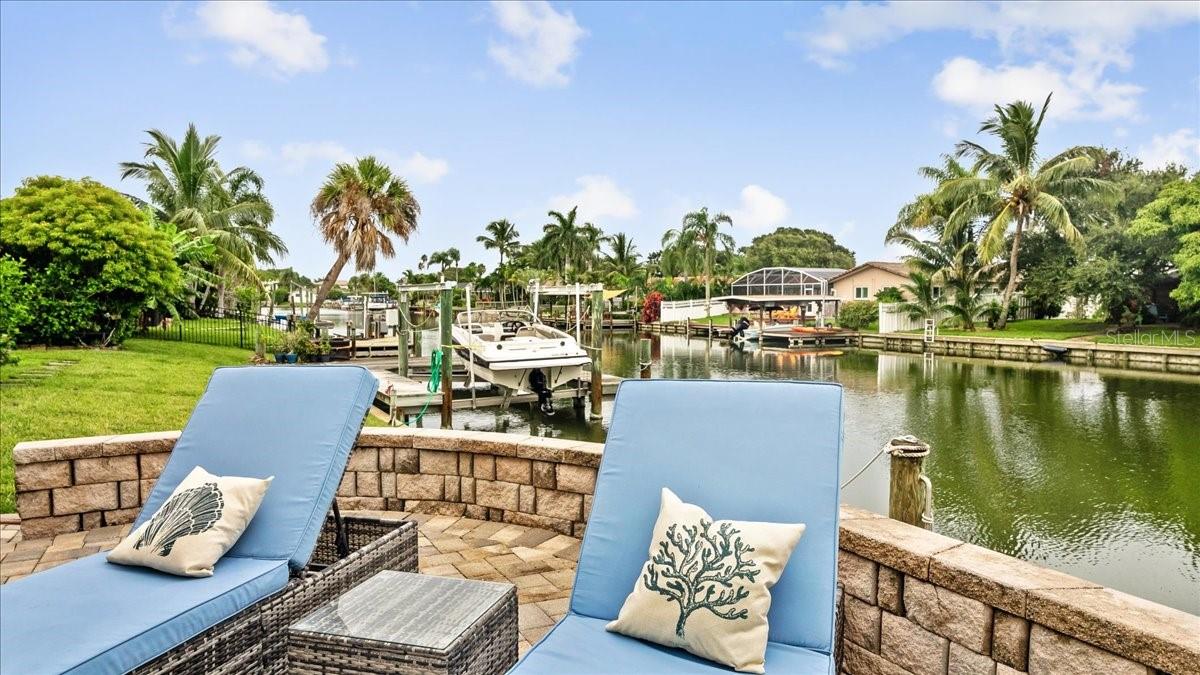 Welcome to your private waterfront retreat—where comfort, style, and coastal living come together effortlessly. This beautiful canal-front home offers direct water access with a private dock and boat lift, making it perfect for boating enthusiasts or anyone who enjoys life by the water.  Inside, the home features four spacious bedrooms with three full baths, including two luxurious master suites—ideal for hosting family and friends while still providing everyone with their own private sanctuary. The open living spaces are filled with natural light and designed for both relaxation and entertaining.
Step outside to enjoy the best of Florida living. The screened-in patio provides a comfortable space to unwind year-round, while the hot tub invites you to soak under the stars after a day on the water. In the front of the home, the private courtyard offers a peaceful setting for morning coffee or evening gatherings.
As a truly special bonus, you can experience unforgettable rocket launches right from your own backyard—watching the shuttle launches light up the sky from the comfort of your private dock or the upstairs balcony.  Whether you're setting out on the boat, relaxing in the spa, or simply enjoying the tranquil canal views, this home delivers the perfect blend of indoor comfort and outdoor lifestyle.  Short term rental allowed + furniture negotiable.