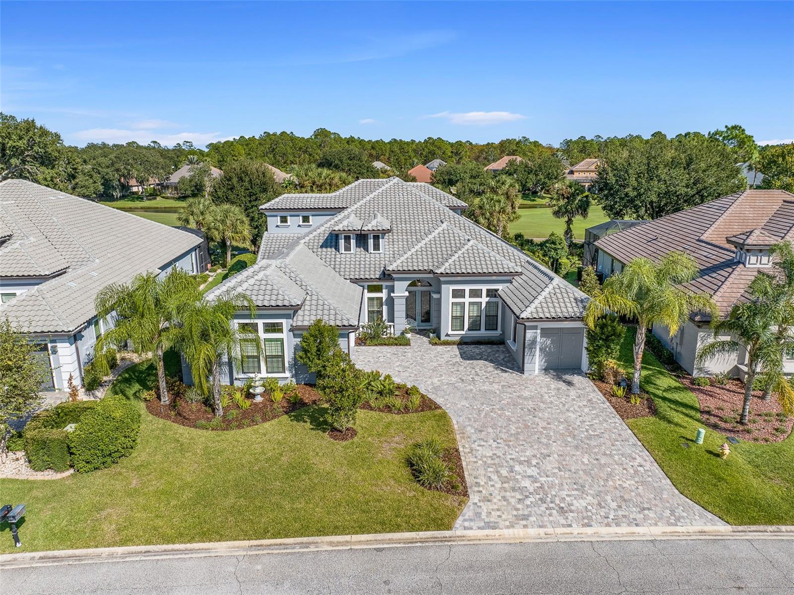 Welcome to 534 Wingspan Drive, an exceptional estate home offering 4 bedrooms plus office plus bonus room, 4 bathrooms, and a 3-car garage, perfectly positioned on a premium homesite along the Westlake Golf Course with breathtaking lake and golf course views. Located on a private estate street within the highly sought-after Plantation Bay Golf & Country Club, this residence delivers the perfect blend of luxury, space, and lifestyle.
From the moment you arrive, the double-door entry with a screened enclosure sets the tone for what awaits inside. At the heart of the home is a beautifully upgraded chef’s kitchen featuring double-stacked cabinetry with a striking two-tone design, a large center island, quartz countertops, tile backsplash, and a farmhouse sink. Outfitted with GE Profile stainless steel appliances, including a propane gas range, this space opens to the breakfast nook with serene pool views and direct lanai access.
The formal dining room is equally refined with tile flooring, plantation shutters, crown molding, and a tray ceiling—ideal for entertaining. The expansive family room impresses with 12-foot ceilings, custom built-ins, and a gas fireplace, anchored by 10-foot vanishing sliders that open fully to the outdoor living area for seamless indoor-outdoor flow.
The owner’s suite is a private retreat with tranquil pool views, tray ceiling with crown molding, an extended sitting area, and direct lanai access. Dual walk-in closets provide ample storage, while the en suite bath features quartz countertops, separate vanities, a soaking tub, and an oversized walk-in shower with floor-to-ceiling tile.
Bedrooms two and three feature plantation shutters and share a bath with quartz countertops and a tiled walk-in shower. Bedroom four serves as a private suite with its own en suite bath and direct lanai access—ideal for guests or multi-generational living. The dedicated office offers double door entry, tile flooring, plantation shutters, 12-foot ceilings, and abundant natural light.
Upstairs, a versatile bonus room offers endless possibilities, complete with tile flooring, a built-in bar with beverage fridge, a private balcony with sweeping golf and lake views, and a convenient half bath.
Step outside to your private outdoor oasis designed for relaxation and entertaining. The pavered lanai features an outdoor kitchen with a gas grill and refrigerator, a cozy wood-burning fireplace, and an oversized pool with solar heating, a waterfall feature, and a sun shelf, all surrounded by privacy hedging while capturing stunning golf course views.
Additional highlights include a three-car split garage (2/1), tile roof, fenced yard area, propane gas for the fireplace, kitchen range, and outdoor grill, under-stair and attic storage, whole-house water filtration and softener, hybrid water heater, and zoned AC systems.
Plantation Bay offers a true resort-style lifestyle with 45 holes of championship golf, two clubhouses, including the new $30M Founders Clubhouse, tennis, pickleball, fitness and spa center, resort-style pools, and an active social scene—all just minutes from the beaches of Ormond Beach. Buyer to receive a substantial discount on club initiation fee—ask listing agent for details.
A rare opportunity to own a meticulously upgraded home with exceptional indoor and outdoor living in one of the area’s most desirable luxury golf communities.