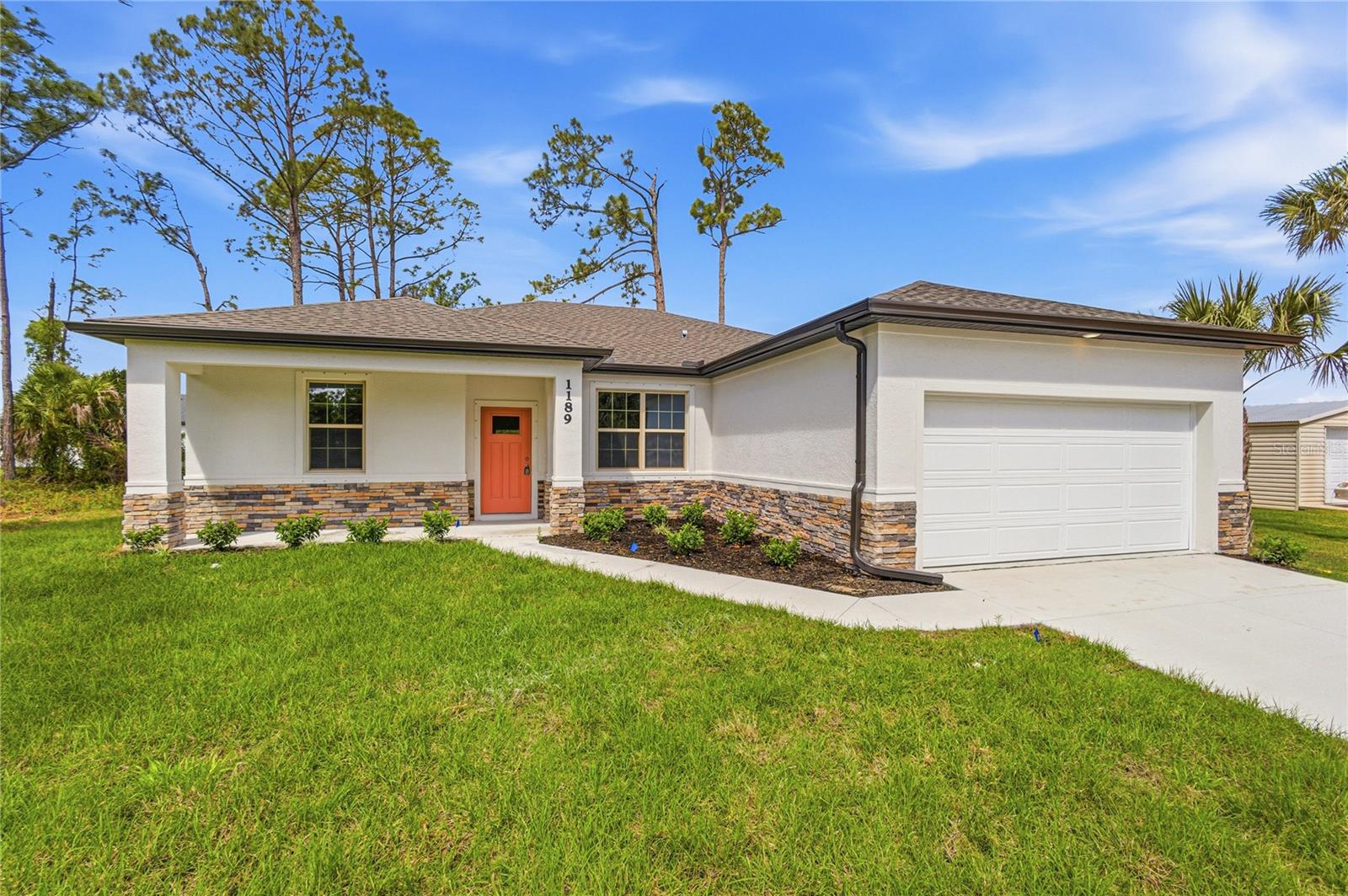 NOW OFFERING 3% TOWARDS CLOSING COSTS WITH PREFERRED LENDER.   Great price with luxury features and ready now! A newly constructed home with city water and septic system in North Port, with no HOA fees! Great location for quick access to shopping, medical conveniences, parks and schools. This affordable new home is ready for you and is just what you've been looking for...No HOA and with city water! This home has 9'4" tall ceilings, a nice and open layout with a versatile floor plan. The house features 4 bedrooms, 2 full bathrooms, dining room, a living room, an open kitchen and a 2-car garage with 1810 square feet of living space. The living space is well-utilized with high ceilings and many windows providing natural light. The interior features will provide you with the quality and luxury you were looking for in your new home. This home has a split floor plan with the primary suite on one side of the home and the guest bedrooms on the other. The primary bedroom has a tray ceiling and large windows that let in natural light. You'll also enjoy a resort-style bathroom with a spacious walk-in shower with floor-to-ceiling tiled walls and a glass enclosure. It also features a linen closet, double vanity and a large walk-in closet. The living room features large windows and several LED fixtures providing plenty of light with access to the covered lanai. The living room is open to the kitchen, where you'll find a huge center island with extra seating for casual dining and plenty of cabinets. The kitchen features stainless steel appliances, Shaker-style cabinets with crown molding, decorative hardware, subway tile backsplash and granite countertops. The dining room is located at the front of the house, with large windows allowing for plenty of natural light. The home includes luxury vinyl plank flooring in the main living areas and bathrooms for durability and comfort. You'll love these floors! They are easy to maintain and offer a modern design, perfect for new homes. Other features include the same beautiful Shaker-style cabinets with hardware and granite countertops in the bathrooms, 5-inch baseboards, a garage door opener, gutters on the exterior, R38 insulation, a 16 SEER HVAC and much more. Visit our model center and compare the features and quality with other homes and you'll see the difference. We make buying easy for you! The photos are of the decorated model home of the same floor plan and not the home for sale.