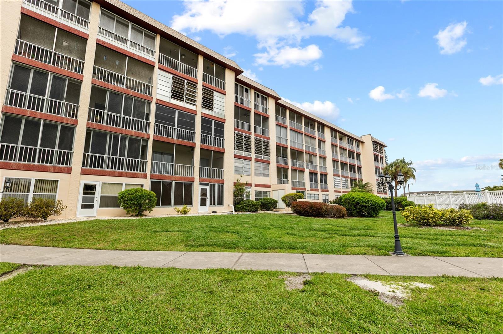 Enjoy affordable Florida living in a prime location at Bayshore on the Lake, where peaceful lake views and poolside scenery set the tone for relaxed living. This desirable 4th-floor, 2-bedroom, 1-bath condo offers 912 sq ft of easy, low-maintenance comfort. The screened patio—overlooking both the community pool and lake—is accessed from sliding glass doors in the great room and primary bedroom, filling the home with natural light and enhancing the open, airy feel.

Located in an active 55+ community, residents enjoy a heated pool, fishing pier, and clubhouse designed for social connection and leisure. Conveniently situated near shopping, dining, and just minutes from the Gulf beaches, this residence delivers the ideal blend of comfort, convenience, and value.

Relaxed, affordable Florida living starts here.
