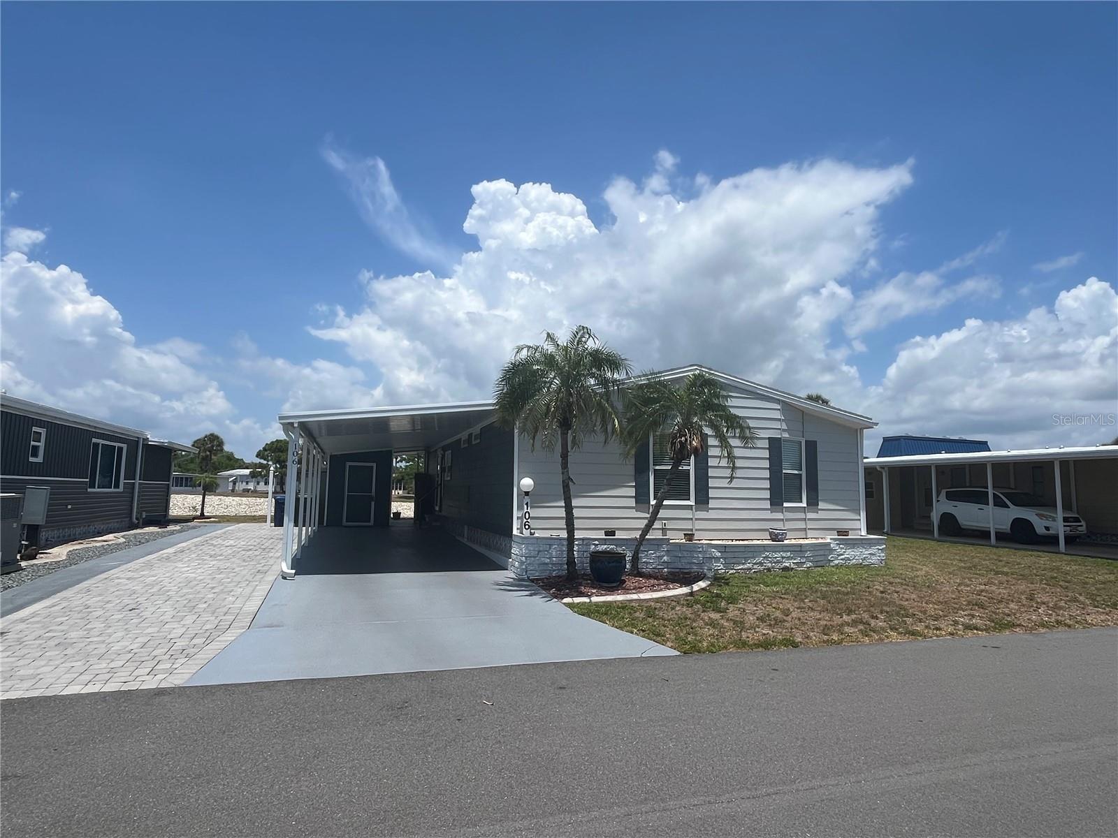 This home has it all, Lake front with a huge rear screen room and patio looking over it, side by side parking for 5+ cars , New AC heat pump in 2022, New washer and dryer in 2023, New water heater in 2024, New shingle roof in 2024,  New front carport section, new gutters, inside boasts Vaulted ceilings, updated kitchen and appliances with range and dishwasher in 2023,  huge rooms with expansive views of the lake from the living room, dining room, screen room and den. Guest bedroom has a walk-in closet and 3 walk in closets in the master bedroom too, 2 huge pantries in the extra-large kitchen and a pass-through space into the living room.
Venice Isle is the premier resident owned over 55 Mobile home Park in Venice.  There are close to 1000 homes with the most active residents. There is always something going on for you to do. We have many Park gatherings and first rate shows on site. The Park has every amenity you can imagine. Come take a walk through both of our 2 clubhouses and make yourself at home. The Park has 2 tennis courts, a fitness center, 2 heated pools, 2 hot tubs, saunas, putting greens, shuffleboard, Bocce ball, miniature golf, art rooms, pool room, TV lounges, card rooms, library, horseshoes, ceramic kilns, 2 huge ballrooms, Sunday services and much more!