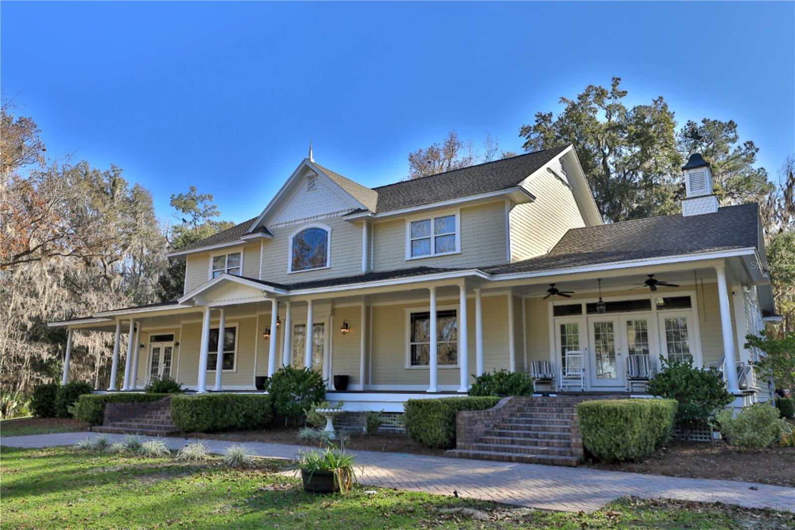 Located along HWY 225 in one of the most desirable equestrian corridors in NW Marion County, this remarkable 109.29+/-acre estate offers a rare blend of high elevation, craftsmanship, and versatility. The two-story residence commands serene views of a picturesque, stocked pond and rolling acreage, creating a setting that feels both private and enduring.
This estate features 5 bedrooms and 3.5 baths, with the first floor being the heart of the home, providing a spacious 2-story ceiling height, with a grand central sitting gathering room, fireplace, and well-appointed bar, making it an exceptional space for hosting, entertaining, or enjoying game days with family and friends. The primary suite is designed as a true retreat. The suite offers a fireplace and a luxurious bath.  The formal living space is perfect as an office or sitting room, and the formal dining room adds timeless elegance and flexibility for both everyday living and entertaining.
Throughout the home, custom woodwork sets this residence apart, with handcrafted moldings, doors, and detailed finishes personally created on-site by the owner, a master carpenter, giving the residence a level of character, quality, and authenticity.  A detached three-car garage and a fully equipped 2-bedroom, 2-bathroom guest house provide ideal accommodations for extended family, guests, or staff.  
The property is further enhanced by three large equipment buildings, well-suited for equestrian operations, agricultural use, a business owner, corporate investor, car enthusiast, or simply seeking a serene retreat with all the amenities. This property offers endless opportunities. Whether your passion is horses or cattle, the farm offers room to ride, train, and raise horses or cattle.  The property is perimeter-fenced, providing ample parking for horse trailers, recreational vehicles, or a car enthusiast's collection.
With its exceptional acreage, prime highway frontage, elevated setting, and proximity to Ocala’s world-renowned equestrian destinations, 13 miles to The World Equestrian Center, and 13 miles to HITS, this estate represents a legacy opportunity in the heart of horse country, perfectly suited for a private retreat, equestrian enterprise, or investment holding. Don’t miss out on this unique chance to own a piece of paradise!