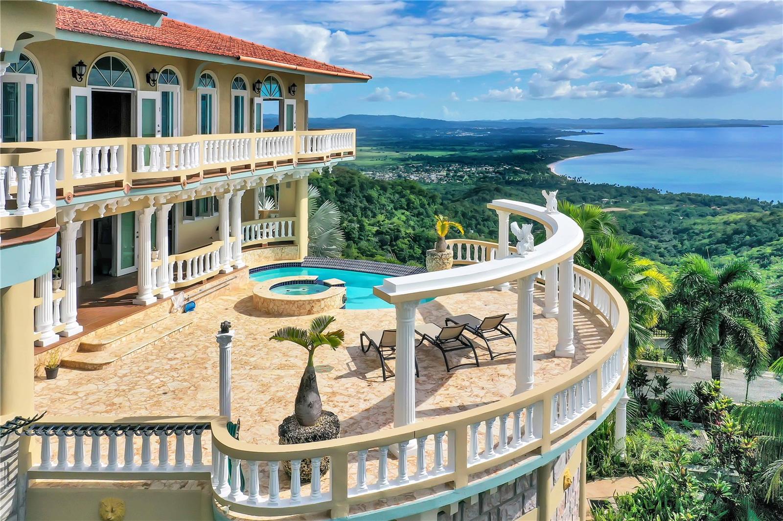 Nestled high above sea level, this luxurious property offers an unparalleled living space with breathtaking panoramic views of the stunning west coast of Puerto Rico. Situated within a private gated community of custom homes, this estate sprawls across 45 acres of pristine land, ensuring exclusivity and tranquility.

The expansive grounds boast a private helipad, horse stables, a guest house, a wine cellar, walking trails, fruit trees and a lookout tower, providing a wealth of amenities for the discerning homeowner. With over 10,000 square feet of living space and an infinity pool facing the amazing view, the property exudes opulence and sophistication.

The main living room and dining area create a grand ambiance, featuring a fireplace and exquisite artisanal woodworking on the ceiling. This majestic space is perfect for hosting gatherings and enjoying the company of friends and family.

In addition to the main residence, a separate guest house offers additional accommodation, while the main house features a private apartment complete with its own kitchen and living space. This thoughtful design ensures that guests experience the utmost privacy during their stay.

Every corner of the property is designed to capture the beauty of the surroundings, allowing residents to revel in the refreshing breeze and mesmerizing views. Whether indoors or outdoors, the property provides an immersive experience of luxury and natural beauty.

Furthermore, this eco-friendly community is equipped with solar panels, wind generators, and a substantial 30,000-gallon water tank, showcasing a commitment to sustainability and self-sufficiency. Embrace the epitome of luxury living in this one-of-a-kind residence that seamlessly combines elegance, comfort, and the allure of Puerto Rico's scenic landscapes.