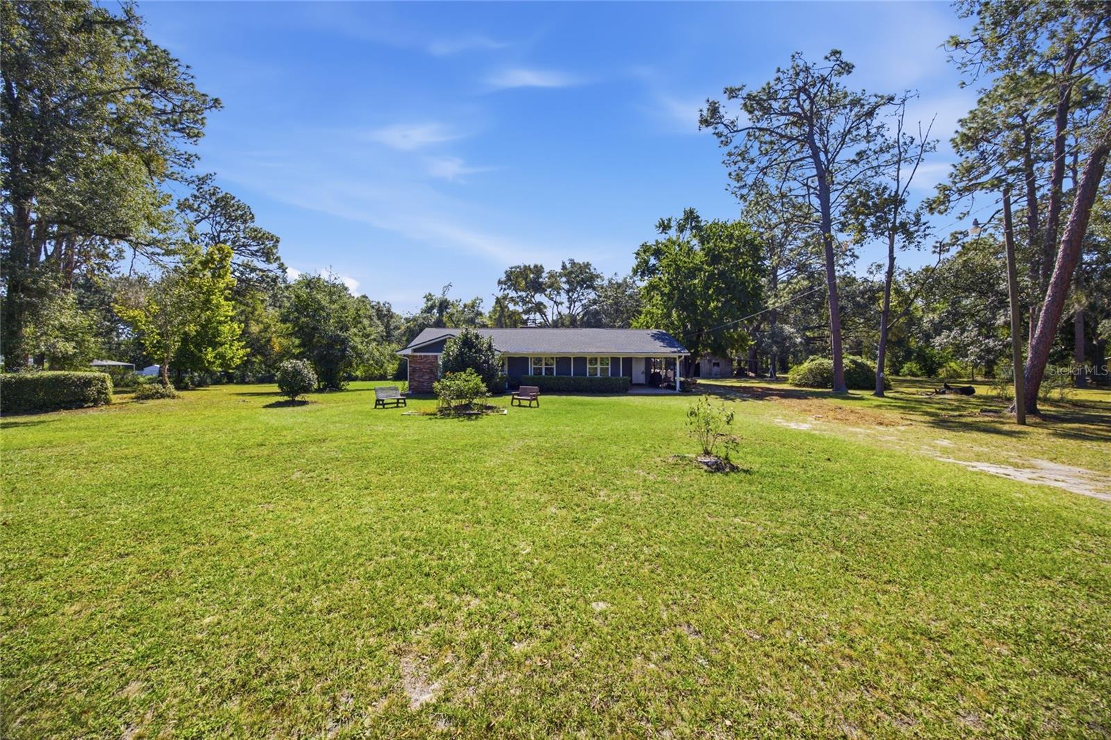 Welcome home to this beautifully updated 3-bedroom, 2.5-bath home situated on 2.5 fully fenced acres in Columbia County. Offering 2,090 heated square feet (2,567 total), this split-bedroom floor plan features an open-concept kitchen and family room centered around a cozy gas fireplace—perfect for everyday living and entertaining.
The spacious approximately 32’ x 22’ primary suite addition provides a true owner’s retreat with a large walk-in closet and an oversized en-suite bath featuring a walk-in shower. The guest bath and half bath have been completely remodeled, and luxury vinyl plank flooring flows throughout the entire home.
Additional upgrades include insulated windows, a roof replaced approximately 5 years ago, and a 22’ x 30’ detached shed with a concrete floor, ideal for a workshop, storage, hobbies, or equipment. Served by Clay Electric, this property offers the privacy of country living while remaining convenient to shopping, dining, schools, and I-75. A rare opportunity to own an updated home with room to spread out and enjoy the outdoors! "Information deemed reliable but not guaranteed. Buyer and agent to verify all measurements, square footage, and property details."