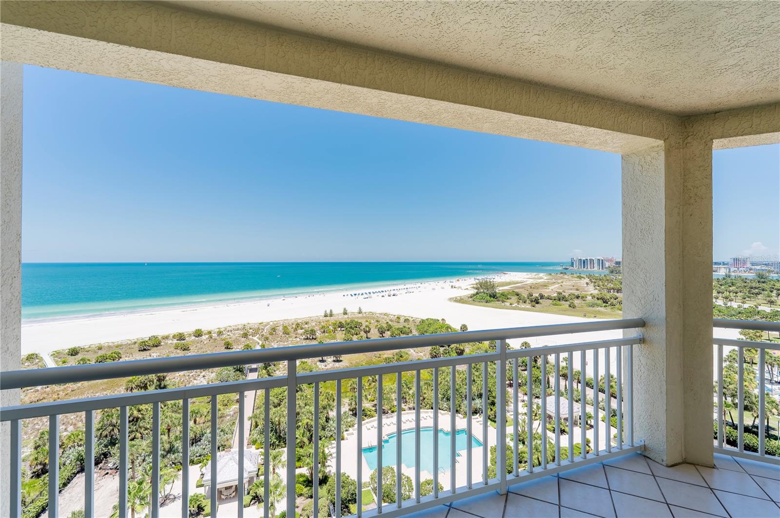 Perfectly positioned on the highly sought-after northwest corner of the SOMERSET building, this spacious three-bedroom, three-bath residence offers approximately 2,521 SQUARE FEET of beautifully designed living space with sweeping panoramic views of the Gulf of Mexico, Clearwater Beach, and the Intracoastal Waterway. *** 

Floor-to-ceiling glass doors flood the home with natural light and seamlessly connect the living room, kitchen, and primary suite to an expansive wraparound balcony, creating the perfect setting to enjoy spectacular sunsets, coastal breezes, and ever-changing water views.  ***

The open-concept kitchen is designed for both everyday living and entertaining, featuring solid wood cabinetry and a center island overlooking the main living area. Warm hardwood flooring, plantation shutters, and a light color palette create an inviting coastal atmosphere throughout the residence. A NEW AIR CONDITIONING system provides modern comfort and peace of mind. ***

The thoughtfully designed SPLIT-BEDROOM floor plan offers privacy for family and guests. The generous primary suite enjoys direct balcony access, stunning Gulf views, a spa-inspired bath, and spacious walk-in closets, while the guest suites offer comfort and beautiful natural light. ***

Residents of The Grande enjoy an exceptional collection of resort-style amenities including 24-hour guard-gated security, concierge service, two beachfront pools, a large spa, poolside cabanas, a beachfront pavilion with grilling area, fitness center with sauna and steam room, tennis courts, billiards, social rooms, private beach access, under-building parking, and additional storage. ***

Perfectly located directly across from the Sand Key Shoppes, you'll enjoy convenient access to restaurants, cafés, boutiques, and everyday conveniences, while the Jolley Trolley provides easy transportation to Clearwater Beach, Dunedin, Tarpon Springs, and beyond. *** 

Whether you're searching for a full-time residence or an exceptional beachfront retreat, this is a rare opportunity to experience one of Sand Key's premier luxury addresses.