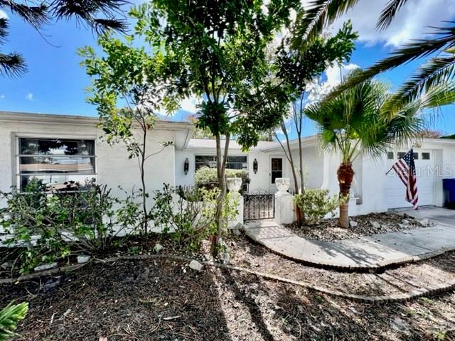 ATTENTION INVESTORS, FLIPPERS & CONTRACTORS: THIS HOME IS FOR YOU!!! This once-lovely GEM at 7024 Parrot Dr, Port Richey in the FANTASTIC community of Regency Park in SUNNY FL features 2 bedrooms, 2 bathrooms, 1 car garage in a NO HOA, NO CDD & NO FLOOD ZONE! Key exterior features are UNIQUE front elevation reminiscent of mid-century Spanish-Mediterranean style with its arches, front courtyard, rain gutters & mature tropical landscaping including BEAUTIFUL palms. The OPEN FLOOR PLAN consists of the foyer, kitchen, dinette, family, living & dining rooms. As you step inside, 1974 CLASSIC VINTAGE is what comes to mind - from the colorful carpet to the ELABORATE iron floor to ceiling railings that adorn the foyer to Brady Bunch window drapes are all reminiscent of this era. The spacious kitchen features all appliances, pantry closet, double sink & breakfast bar with a pair of RETRO pendant lights. Off the dining & family rooms are double glass sliding doors into the Florida room/lanai. In this POPULAR El Dorado model, the family room can easily be turned into a third bedroom. The primary bedroom can easily fit king size furniture, has a GENEROUS walk-in closet, ceiling fan & private bathroom with dual sinks & tub/shower combo. Located at the front of the home is the second bedroom which has ample closet space & a ceiling fan. More great features are pretty chandelier in the dining room, lots of storage options throughout the house, oversized garage & GORGEOUS thick wood etched custom front door. A COOL FACT about this house is that it has NEVER BEEN SOLD YET & has remained in the family since it was built in 1974. Naturally, the lucky buyer needs to do their due diligence; however, the electrical panel looks electrifyingly great, the water heater appears tall & stout & the AC is cooling the house. The shingle roof has been recently replaced from the original tile roof (permitted, 9/2013). This home needs cosmetic updates & this is already reflected in this price. There is a LOT OF SWEAT EQUITY IN THIS HOUSE! Can you transform it to an ELEGANT BEAUTY? The location is IDEAL near restaurants, shopping, schools, places of worship, medical plazas, beaches & tourist attractions. MAKE THIS YOUR FUTURE HOME!