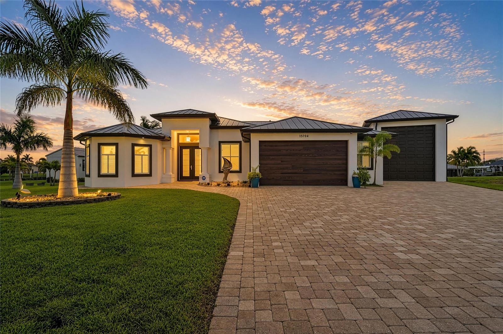 BACK ON THE MARKET, priced to sell, and TURNKEY FURNISHED!!! Just bring your suitcase and you are ready to live the Florida waterfront lifestyle you’ve always dreamed of. BEAUTIFULLY FURNISHED, this exquisite home can be yours today! Impeccably cared for, this home has so many upgrades and features, including double lot with 213 FEET of WATERFRONT, two private boat docks, 10,000 lb covered boatlift complete with water and electricity, plus a 16x50 RV garage with 12x14 door. Now, moving on to the house, this home features a new roof in 2025, including all new soffits, facia, gutters & downspouts on both the house and the RV garage. Feel secure with impact doors and windows throughout, a hurricane grade front door and garage door, plus a hurricane shade on the lanai with remote. Relax in your SALTWATER POOL with all new pool equipment, and infinity no-seeum screens. Prepare a meal in your gourmet kitchen with all new appliances, or, do your cooking outside in your outdoor kitchen by the pool. WHAT MORE COULD YOU ASK FOR? Let’s add just a few more perks … tray ceilings, custom lighting and window furnishings, fresh exterior paint, pavered driveway, and again, FULLY TURNKEY! At this price, THIS HOUSE WON’T LAST LONG. DON’T WAIT to schedule your showing!