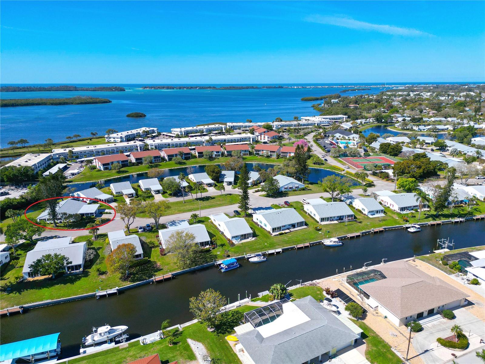 NESTLED WITHIN A VIBRANT, nearly 90-acre bayfront community, this delightful turnkey-furnished two-bedroom, two-bathroom concrete block villa with storm shutters offers the perfect blend of comfort, charm, convenience and peace of mind. Tucked away on a quiet cul-de-sac with serene pond views and surrounded by lush green lawns, this villa is just a short stroll from the exceptional clubhouse and resort-style amenities, you’ll be proud to call this your Florida home. STEP INSIDE AND DISCOVER the many updates that add to this villa’s value and peace of mind: 2025 water heater, 2024 air conditioning system, 2023 roof and 3rd nail hurricane roof reinforcement, 2023 GE stainless appliance suite, and 2023 ceiling fans. THE BRIGHT AND CHEERFUL great room opens to a private patio and scenic outdoors, offering a perfect setting for relaxing or entertaining. The home features a wide carport, newer driveway, secure outdoor storage (ideal for bikes, beach gear, or fishing equipment), and an indoor laundry space for convenient everyday ease. INSIDE YOU’LL FIND a thoughtfully designed open-concept layout with a split-bedroom floor plan for privacy and functionality. The spacious primary suite includes a large walk-in closet with attic access and an ensuite bath with creamy tile, shower safety bars, and coordinating vanity and fixtures. The secondary bedroom, located up front, has its own adjacent bathroom with a tub/shower combo and safety bar for easy entry. THE SPACIOUS KITCHEN is well-equipped with a complete GE stainless appliance package, abundant white on white cabinetry with updated hardware, generous countertops, and a convenient closet pantry, all topped off with modernized lighting and a tray ceiling installed in 2023. A pass-through to the dining area enhances flow for easy entertaining. The combined living and dining space offers versatility for your preferred layout and hosting needs. LOVE THE OUTDOORS? You’ll appreciate the cozy rear patio—extend it up to 27 feet across the back for even more living space—and consider adding a retractable awning for sunny days. Additionally, the shaded carport doubles as a welcoming front porch. You can grill and relax in both spaces. ENJOY PICTURESQUE COMMUNITY WALKING PATHS that wind past butterfly gardens, lagoons, lakes, and bayfront views, leading to a peaceful pavilion. For the socially inclined, it’s just a short stroll to the clubhouse and amenities galore. BOATING ENTHUSIASTS will love the boat docks and kayak storage—just a one-time $25 fee. While Mount Vernon is a pet-free community, service animals are welcome with proper documentation, and golf carts are permitted for residents with medical needs. COMMUNITY AMENITIES INCLUDE Clubhouse, banquet room, billiards, ping-pong, game/library room, lakeside veranda, heated pool, tennis, pickleball, shuffleboard, bocce, spa, sauna, workshop, putting/chipping green, butterfly garden, kayak launch & storage, bayside pavilion, bird sanctuary, and nature-filled walking trails across nearly 90 acres. MONTHLY DUES COVER water, sewer, trash/recycling, pest control, cable, internet, exterior and landscape maintenance, and insurance. START LIVING YOUR DREAM and embrace the blissful Florida lifestyle. Schedule your private tour today!