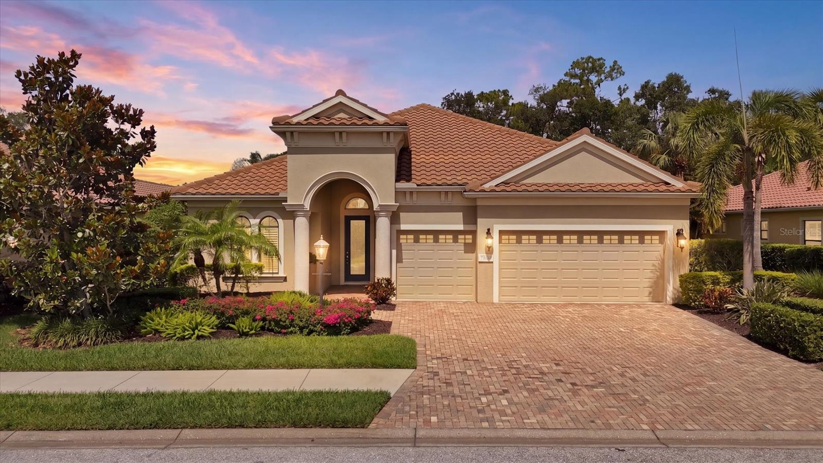 Experience maintenance-free, lock-and-leave living in the prestigious Lakewood Ranch Golf & Country Club with this beautifully updated Neal Signature Homes Castellina model. Offering over 2,600 square feet, this thoughtfully designed residence features 4 bedrooms, 3 bathrooms, a private den, and a desirable open-concept floor plan ideal for everyday living and entertaining. Rich wood-look tile flooring, neutral paint, crown molding, plantation shutters, designer lighting, and upgraded ceiling fans create a timeless, elegant ambiance throughout. The heart of the home is the renovated 2025 kitchen, showcasing white shaker cabinetry, quartzite countertops, a large center island with beverage cooler, built-in Bosch refrigerator, Bosch oven, microwave and dishwasher, Thermador gas cooktop, under-cabinet lighting, and neutral tile backsplash. An adjacent dining nook offers tranquil views of the sparkling pool and golf course. The expansive great room features coffered ceilings and pocketing sliding glass doors that seamlessly blend indoor/outdoor living. The private den is enhanced with custom glass French doors and designer wallpaper, creating the perfect work-from-home space. The privately situated primary suite is a peaceful retreat overlooking the lanai, featuring a tray ceiling, dual walk-in closets, and a luxurious ensuite bath with split vanities, spacious walk-in shower, and private water closet. Three additional guest bedrooms and two full guest bathrooms provide comfortable accommodations for family and visitors. The laundry room was beautifully updated in 2025 with quartzite countertops, new sink, and designer faucet. Step outside to your private Florida retreat featuring a large saltwater pool, recently replaced Pentair gas pool heater and pool pump, pavered lanai, dry bar with beverage cooler, and a re-screened pool cage (2024). Surrounded by lush tropical landscaping, this private homesite enjoys picturesque water and golf course views, creating the perfect setting for year-round outdoor living. Additional upgrades include a new Bosch HVAC system with surge protection (2025), recently replaced Rheem water heater, hurricane shutters, and a spacious three-car garage with a new garage door opening system. Ideally located within one of Lakewood Ranch's most sought-after gated golf communities, this exceptional home offers the perfect combination of luxury, comfort, and carefree Florida living. Lakewood Ranch Golf & Country Club offers the best resort lifestyle you could possibly ask for. The only four course private golfing community in the area, Lakewood Ranch Golf and Country Club boasts 3 Championship courses designed by the legendary Arnold Palmer. Several different membership packages are available, which, depending on your membership, provide access to all 4 courses, 3 impressive clubhouses, a state-of-the-art golf academy, and 2 golf practice facilities. You can also enjoy 20 full size tennis courts, 20 pickleball courts, 2 full size heated swimming pools, Bocce ball and tournament croquet courts, and a full social calendar of events. There is a 24-hour fitness center with over 70 weekly fitness classes. With first class dining available at the 3 clubhouses within the grounds, you would also have access to plentiful community events throughout the year. Don’t miss the opportunity to make this property yours, in America's top selling, multigenerational, master planned community!