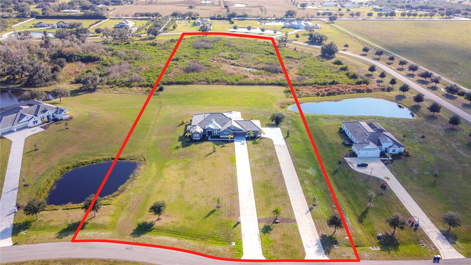 ***Priced WELL below reproduction cost + nearly $200k in options added.***  If you’re looking for a home that combines modern luxury in an away-from-it-all setting with easy access to wonderful Sarasota, 3586 Recurve Circle is the property for you.  This nearly new 5 bedroom, 4 bathroom Grand Cayman estate is situated on an expansive, private 8 acre lot in the gated Hampton Lakes community with no rear neighbors and a serene conservation view.  Located in Flood Zone X, flood insurance is not required.  Plus, hurricane impact windows and reinforced garage doors add to your peace of mind.  Built with an extended lanai and graced with an additional bonus room/5th bedroom, this home is perfectly designed for indoor-outdoor living.  Whether you’re looking for a spacious property to connect with family and friends or just want room to breathe, this property checks these boxes and more.  Soaring ceilings greet you at the front door with an easy flowing floor plan that leads you past the office/den, living room, dining room, and butler pantry to your beautiful kitchen with impressive quartz countertops and on to the bright, inviting family room.  The spacious primary suite encompasses the entire east side of the home and includes a generous 15x18 walk-in closet, soaker tub, and walk-in shower with waterfall showerhead.  On the western side of the home are 3 more bedrooms with full ensuite bathrooms and a bonus room with a large closet that can be used however you see fit.  The home has thoughtful options above the base model including an additional bedroom, double driveway, and generous screened and covered outdoor space (pre-plumbed and wired for an outdoor kitchen) perfect for entertaining or taking in the peaceful view.  Your cavernous garage (1,325 sq ft) has room for four vehicles and more.  Situated away from it all but close to everything - just minutes from Lakewood Ranch and Waterside Place.  You would spend significantly more to build the base model of this home so come embrace all this estate home has to offer and imagine yourself in this unique opportunity.