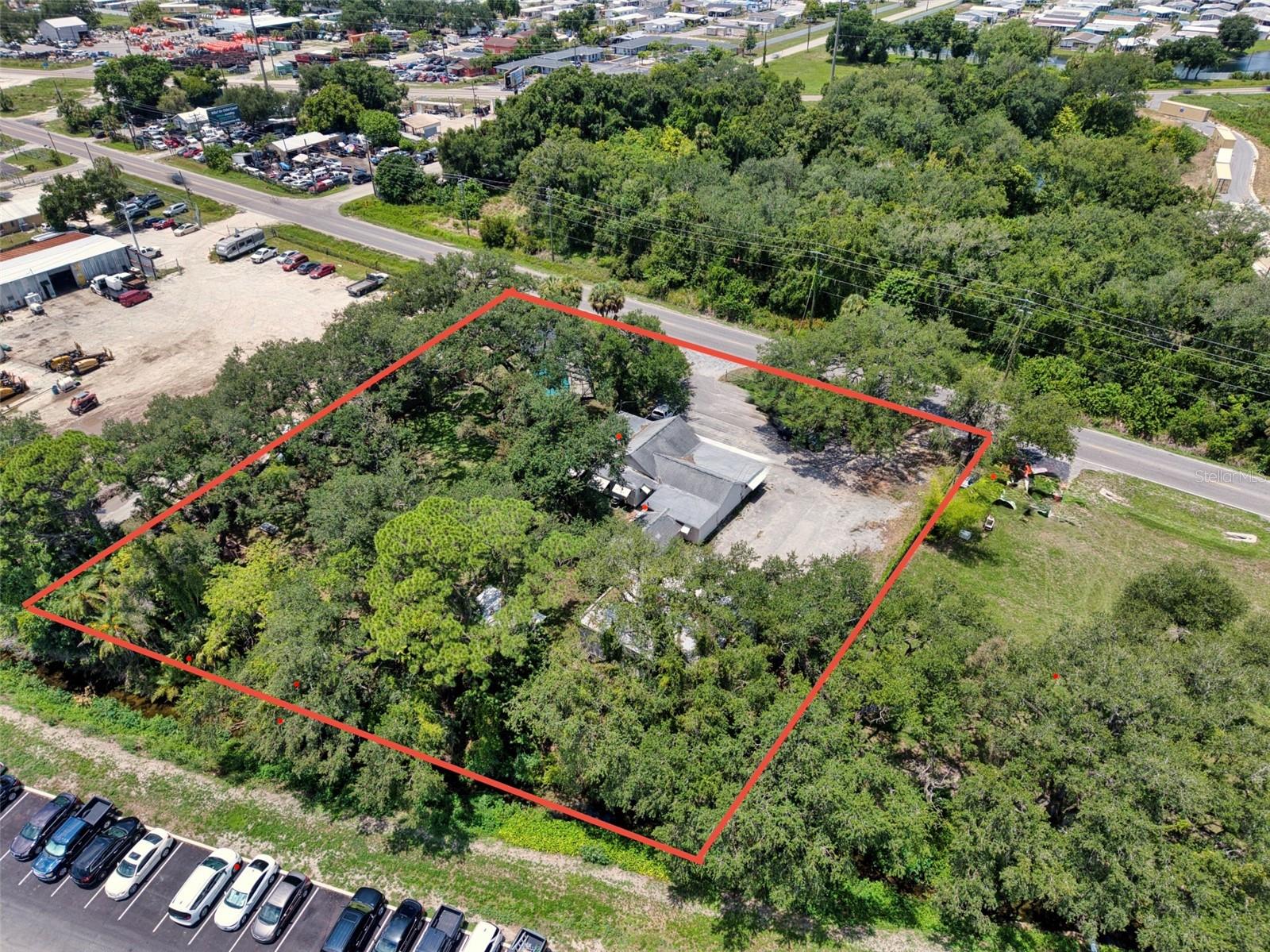 Rare opportunity to own approximately 1 acre across two contiguous parcels  (4727 & 4815) offering a unique combination of residential and commercial functionality. Whether you're a business owner, investor, or someone looking for a property unlike anything else on the market, this offering presents endless possibilities.
The property features an existing concrete commercial warehouse building, multiple parking areas, two points of ingress and egress, and approximately 9,500 vehicles per day (FDOT 2025 AADT), providing excellent visibility and accessibility.
The residential home conveys as-is and will require renovation, offering the opportunity to restore the existing residence while benefiting from the property's unique commercial improvements. Zoned HM (Heavy Manufacturing) with Industrial Heavy (IH) Future Land Use, this property offers exceptional value for buyers seeking a rare combination of existing commercial infrastructure and residential use.
Buyer to verify all measurements, zoning, permitted uses, and intended use with Manatee County.