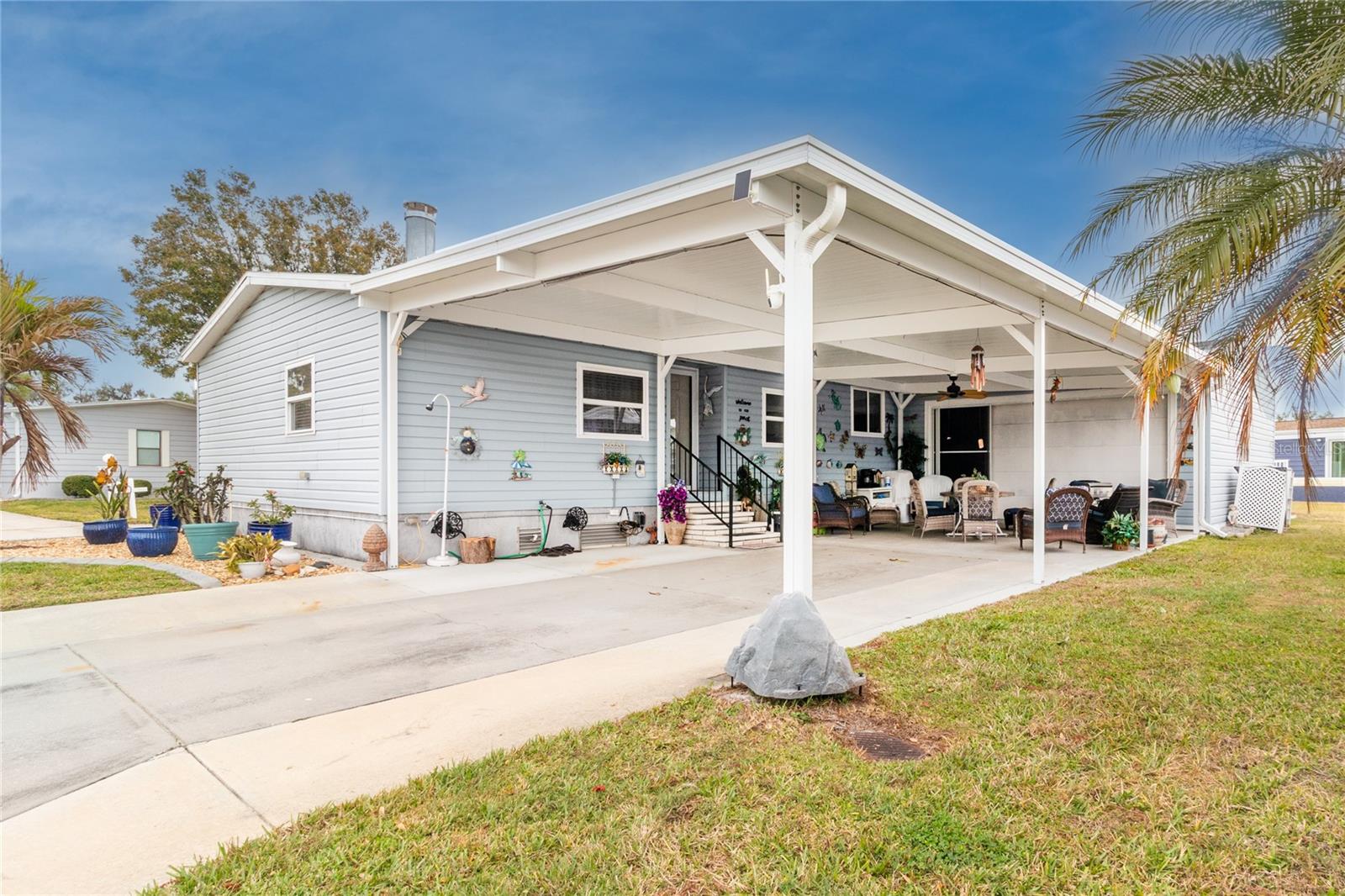 AMAZING!  LAND OWNED home on a large corner lot in the 55+ community of Ridgewood Meadows.  Looking for a large home, this home features over 1,900 sq. ft. of living space. Outside, this home has a 40’x 20’ carport which was added just a few years ago, plus a 2-car garage with loft for all the storage you will ever need.  The owner had the drive way and carport area widen so there is plenty of room for multiple cars and golf carts.  A new roof was installed with upgraded windows throughout.  Inside, the home has a formal living room with fireplace, a dining area and a split floorplan for the bedrooms.  A beautiful large (13’x20’) family room is the perfect place for family gatherings.  The kitchen is very large with many cabinets and two pantries, large open counters for creating those perfect holiday dinners for your northern guests!  This home has a split floorplan with 2 guest rooms and then the primary bedroom with a custom bathroom.  Need office space or craft area, this home has a huge all-season room (10’x25’) which will accommodate any activity you will need.  This is a great home with way too many features to list.  The Meadows community has very low HOA/Condo fees which include lawn maintenance.  A beautiful clubhouse, pool, spa, tennis courts, Pickle ball courts, shuffle board and a fun outdoor fitness area.  Golf cart and small pet friendly.  Ridgewood has close access to I-75, many restaurants, the Ellenton Outlet Mall, Manatee County Library and provides 24-hour gated security.  The Ridgewood Meadows is a great 55+ community offering many activities and social events to enjoy.  All room sizes are approximate. All information is deemed reliable but should be verified by buyers and/or buyer's agent.