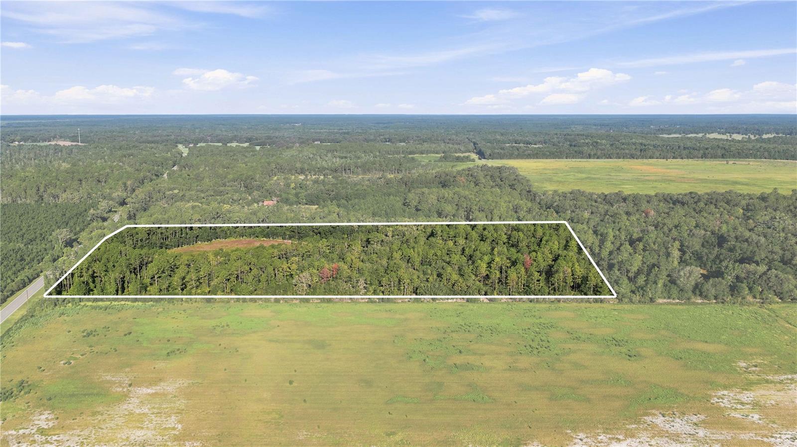 Rare opportunity to own approximately 20 acres of A-1 General Agriculture land with approximately  660 feet by 1,320 feet, offering excellent road frontage, accessibility, and flexibility. Conveniently located near Ocala, Gainesville, and major highways, it combines the privacy of country living with convenient access to nearby amenities. This unique offering consists of multiple parcels and features open, usable acreage suitable for farming, livestock, equestrian use, a private estate, or other agricultural and recreational opportunities.

Enhancing the property's natural appeal is a seasonal wet-weather pond that typically fills during periods of rainfall, creating a peaceful setting and attracting local wildlife. The pond is currently dry due to recent weather conditions, and water levels vary seasonally based on rainfall.

A recorded ingress and egress easement is in place, providing legal access to the rear parcels. Buyer/buyer's agent is responsible for verifying acreage, dimensions, zoning, land use, easements, flood zones, and all intended uses with Marion County.