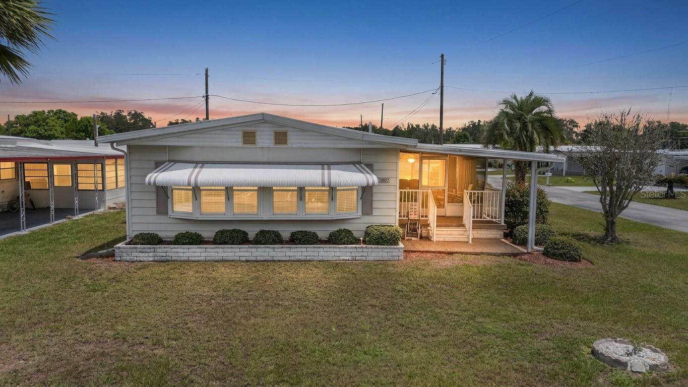 Welcome to sunny Florida living in the highly desirable Betmar Acres, where you own the land and enjoy an active 55+ golf community lifestyle with a low annual fee of just $448! This nicely maintained 2-bedroom, 2-bathroom home is situated on a desirable corner lot and offers important updates including a membrane roof, double-pane windows, and a 2020 A/C system. Inside, you'll find a spacious floor plan featuring two separate living areas. The primary bedroom includes a ceiling fan, built-in closet, and private ensuite bathroom. The guest bedroom offers convenient access to the Jack-and-Jill style guest bath. The family room is open to the kitchen, creating a comfortable gathering space, while the bright living room at the front of the home provides additional room for relaxing and entertaining. The laundry area is conveniently located inside the home. Enjoy Florida's beautiful weather from the welcoming screened room at the front of the home, complete with sliding door access to the interior. The attached storage/golf cart garage at the front of the carport provides plenty of extra storage space. As an added bonus, the nearly new golf cart is included with the sale and has been barely driven! Premium Whisper W7 Halo Series golf cart in excellent condition! less than one year old! Loaded with a maintenance-free lithium battery, luxury diamond-stitched seating, touchscreen display, LED lighting, fold-down rear cargo seat, premium steering wheel, and plenty of storage. Charger and owner's manual included. A stylish, reliable golf cart that's ready to cruise the neighborhood, campground, or golf course! Residents of Betmar Acres enjoy an abundance of amenities, including golf, swimming pools, hot tubs, clubhouses, pickleball, tennis, shuffleboard, bocce ball, and countless social activities. Conveniently located near shopping, restaurants, premier medical facilities, and just a short drive to some of Florida's most beautiful Gulf Coast beaches, this home offers the perfect opportunity for seasonal or year-round living. Come see for yourself what Florida retirement living is all about!
