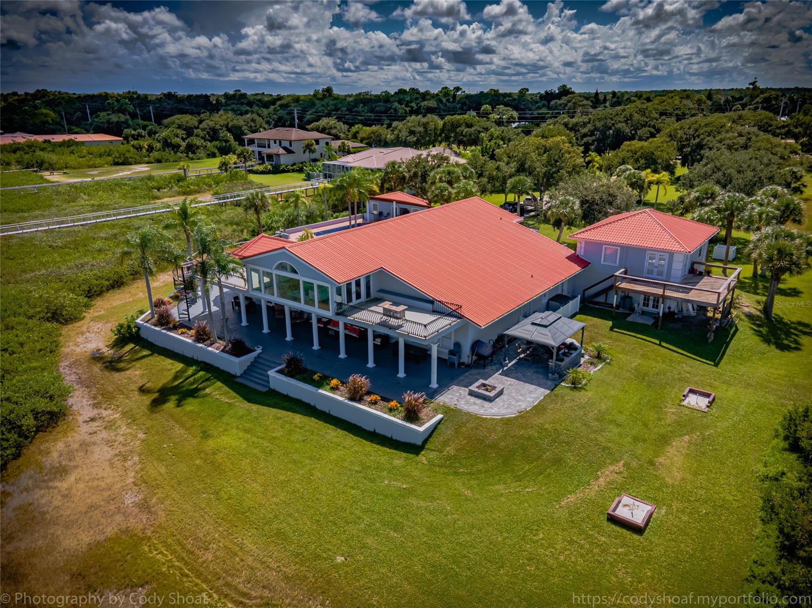 Direct Intracoastal Gated pool home Estate located on a 3 acre parcel that may be subdivided.*** outside oasis features summer kitchen with **Multiple BBQ stations, Santa Maria grill, pizza oven, fire pit, and granite countertops.** Pool cabana offers poolside kitchen with water, electric and an unfinished full bath. There is a one bedroom apartment with full bath above the garage that is on a separate electric meter. The apartment mirrors the look of the home and has new appliances. A deep water dock sits directly on the deep water intracoastal. ***Now the home!! *** which consists of 4 bedrooms: one currently being used as a media center and one as a game room with pool table, shuffle board, darts and bar.
Each of these two rooms have full baths adjacent to them. master en suite located on the main level*** boasts fireplaces along with two walk in closets leading to the master bath. there is also a fireplace above the free standing soaking tub, separate shower and dual granite top vanities.
kitchen offers wolf gourmet stove and convection oven***, free standing ice maker***, 2 refrigerators, and a blend of granite, quartz and glass tiles. There is also a half bath located off the foyer.***a wine room*** Bar/Library*** is a work in progress*** an ** observation room ***overlooks the vista to watch the sun rise and for star gazing. The flooring throughout is all hard wood. The interior and exterior have been painted recently. ;Water: City