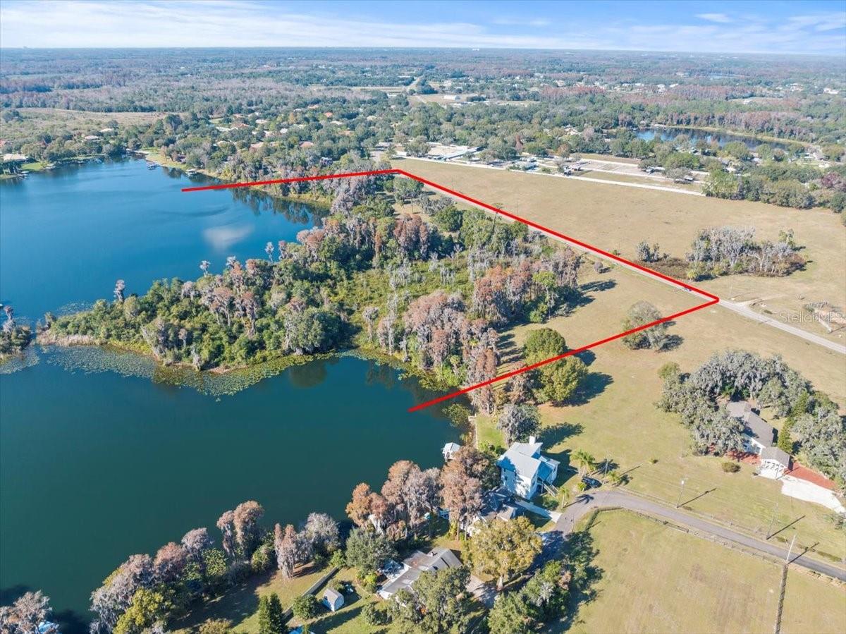 One of Odessa's most beautiful properties with private picturesque setting boasting breath-taking lake views and exceptional lake frontage on two ski sized lakes. This "one-of-a-kind Estate Parcel" has the perfect balance between open pasture for your cattle or horses as well as beautifully wooded areas. This exceptional property is in an excellent area with many beautiful lakefront estates and friendly neighbors within a short walk. Enjoy the quiet country setting just a short drive from shopping and restaurants at the Citrus Park Mall or dinner on the Gulf of Mexico. Must See to appreciate. At owner's request, please do not go onto the property without the listing agent being present.