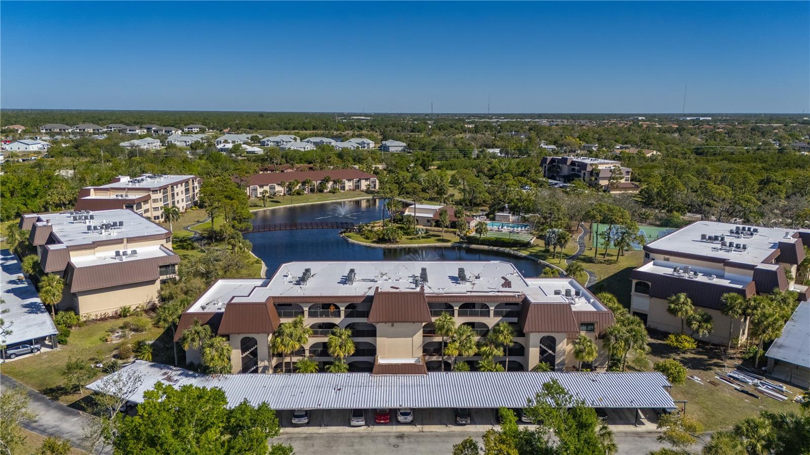 TURN-KEY Florida waterfront living awaits at Rolls Landing, a highly sought after GATED WATERFRONT community offering DIRECT ACCESS to Charlotte Harbor and the Gulf of Mexico. This beautifully updated, MOVE-IN ready condo features tranquil lake views and an unmatched amenity package, including first come, first serve boat slips, a NEWLY REBUILT 300 foot fishing PIER with NEW DOCK, 24 boat slips, and a waterfront tiki hut perfectly positioned for enjoying spectacular sunrises, sunsets, and abundant Florida wildlife. Whether you are searching for a seasonal retreat, investment property, vacation home, or full time residence in Punta Gorda, this exceptional home delivers the ultimate Southwest Florida lifestyle. Step inside and discover a thoughtfully renovated interior showcasing crown molding, modern neutral tile flooring throughout the main living areas, and an open concept floor plan designed for both everyday living and entertaining. The upgraded kitchen is a standout feature, complete with stainless steel appliances, a breakfast bar, elegant lighting, a spacious walk in pantry, and even new dishes and silverware included for a truly turn key experience. The bright and inviting living room opens through sliding glass doors to a private screened patio overlooking the lake, creating the perfect setting for morning coffee, outdoor dining, or relaxing while enjoying peaceful water views. The spacious primary suite serves as a private retreat with direct lanai access and a stylish barn door leading to a beautifully updated ensuite bathroom. This luxurious space features dual vanities, designer tile accents, a large walk in closet, and an oversized walk in shower. Guests will appreciate their own updated bathroom, offering both privacy and comfort. Additional highlights include an interior laundry area with a stackable washer and dryer, hurricane shutters, a newer electrical panel, a 2021 water heater, and a 2017 air conditioning system. A covered carport and private storage unit provide added convenience and functionality. Rolls Landing offers an exceptional collection of resort style amenities designed to complement an active waterfront lifestyle. Residents enjoy 24 hour guarded entry, a heated swimming pool and spa, fitness center, tennis courts, pickleball courts, shuffleboard, bocce ball, billiards, and a clubhouse with a full kitchen for entertaining and social gatherings. Additional conveniences include a community library with workspace, outdoor fire pit, gas grills, community garden, car and boat washing station, and scenic walking and biking trails throughout the beautifully maintained grounds. For boating enthusiasts, the community provides kayak storage, dry boat storage, boat trailer parking, and boat slips available on a first come, first serve basis. The newly rebuilt fishing pier creates the perfect setting to fish, relax, or simply enjoy the breathtaking waterfront scenery. Conveniently situated just minutes from downtown Punta Gorda, residents have easy access to waterfront dining, boutique shopping, farmers markets, community events, and local festivals. With quick access to Interstate 75, Punta Gorda Airport, Fort Myers, Sarasota, championship golf courses, and Gulf Coast beaches, this location offers the very best of Southwest Florida living. Simply bring your toothbrush and start enjoying the Florida lifestyle you have been dreaming about.