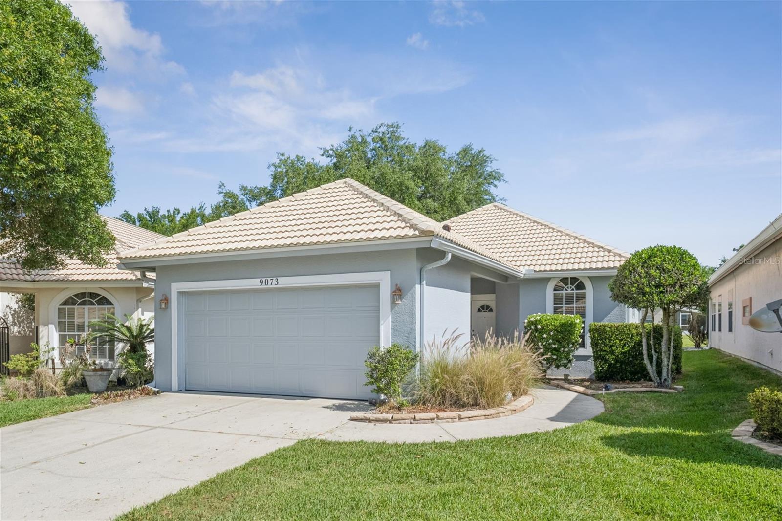 This well-maintained 2-bedroom, 2-bath home in the desirable Saint Andrews area of the Country Club of Mount Dora offers comfort, convenience, and a welcoming open layout. The spacious living and dining areas flow seamlessly together, creating an ideal setting for both everyday living and entertaining. A large screened patio overlooks the backyard and features a recently added new roof, perfect for enjoying Florida’s outdoor lifestyle. Since purchasing in 2020, the current owners have thoughtfully updated the home with fresh interior and exterior paint, a new AC system, new laminate wood flooring, added gutters, and a French drain for improved drainage. The south-facing orientation helps keep the home comfortable by avoiding harsh afternoon sun. A full two-car garage adds practicality, while low-maintenance living is enhanced by lawn care included at just $87.74 per month. Residents of Saint Andrews enjoy access to a private pool, clubhouse, and fitness center, along with optional social and golf memberships at the Country Club, which also features dining and regular events. Located in charming Mount Dora—known for its local restaurants, boutique shopping, and year-round festivals—this golf cart-friendly community is ideally situated within an hour of Central Florida attractions, as well as both the Atlantic Ocean and Gulf Coast beaches. Schedule your private showing today to experience all this beautiful home has to offer.