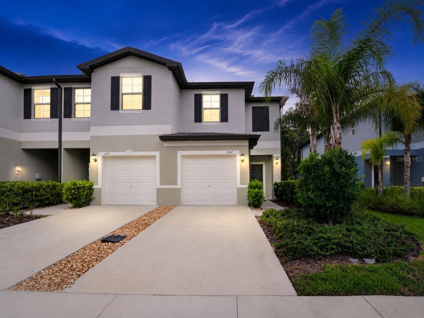 Welcome to this Nearly New, Corner-unit Townhouse in Holiday, Florida! Built in 2023, this 2-Bedroom, 2.5-Bath Home Boasts a Bright, Open Floor plan downstairs, seamlessly connecting the large Living Room, Kitchen and Dining Area. The Kitchen Impresses with White Cabinetry, Granite Countertops, and a Bar Seating area for Casual Dinning, while the Dining Space fits a Table for six to eight people. The Upstairs Loft is ideal for an Office or Relaxation space.  The Primary Bedroom is Exceptionally Spacious, featuring a Large Walk-in Closet and a Luxurious en-suite bath with double sinks and a walkin shower. The Secondary Bedroom is also very Ample in Size an includes a Walk-in Closet and En-suite. A Convenient half bath is located downstairs off the entrance to one Car Garage. Step outside to a large patio backing to a peaceful, private wooded area in your backyard , and enjoy views of a small park right in the community, facing your home. With low monthly HOA fees of just $249, the cost covers lawn care, landscaping, roof maintenance, trash pick up and exterior painting—giving you a truly low-maintenance lifestyle. Centrally located near shopping, schools, and more, and out of the flood zone, this charming community is ready for you to call home. Don’t miss this move-in-ready gem
