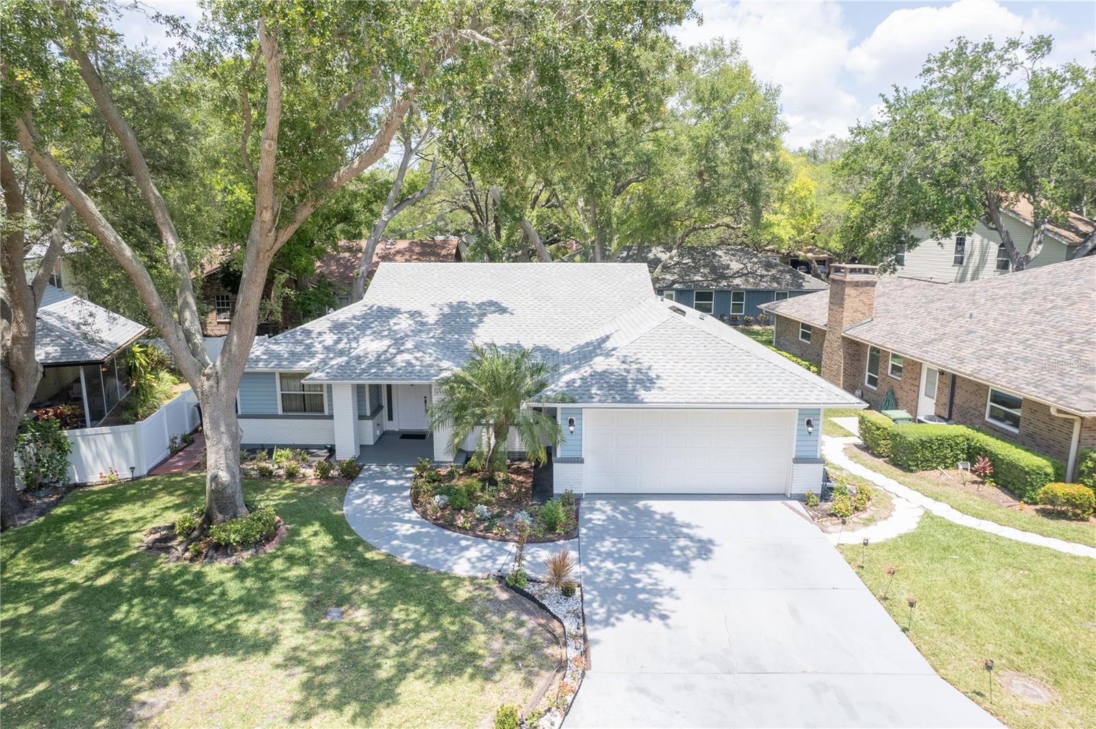 Situated in a well maintained and established community; this beautiful home provides its community members with a low maintenance lifestyle. Arbor Oaks is a NON-AGE RESTRICTED HOA community. The HOA includes internet, exterior lawn maintenance, community pool maintenance, and even irrigation maintenance! This gorgeous home is just steps away from the community HEATED swimming pool. Just 7 miles from the beautiful beaches of Anna Maria Island. Nearby to numerous shopping centers, dining, and entertainment. This location highlights the beauty that Bradenton, Florida has to offer. The interior of the home has been tastefully updated with a brand new gourmet kitchen equipped with a pot filler, built-in spice rack and built in oven, a brand new stainless steel appliance package, new washer and dryer (2026), new all-wood, soft close cabinets, and gorgeous Level 5 Calacatta quartz countertops (all installed 04/2024). The entire flooring throughout the home has been replaced with modern wood-plank tile. NO CARPET ANYWHERE! NEW ROOF! The bathrooms have been redesigned with luxury and modernity in mind. This home offers a split floor plan, as well as a bright and open layout. The sky lights in the ceiling bring character and add even more brightness to this airy home. We welcome you to book your private showing today!