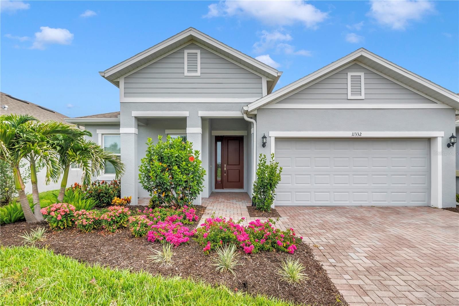 Welcome to 11332 Gallatin Trail, a beautifully designed single-story home in the highly sought-after North River Ranch community. This move-in-ready home has an assumable FHA loan available at 4.25% for qualified buyers. This thoughtfully crafted 3-bedroom, 2-bath residence with a private study offers nearly 2,000 square feet of stylish open-concept living. The popular Margate II floor plan features a spacious great room that seamlessly connects to the dining area and custom gourmet kitchen, creating the perfect space for everyday living and entertaining. The kitchen showcases elegant quartz countertops, designer cabinetry with under cabinet lighting, a large center island, a custom glass tile backsplash, and abundant storage including an upgraded pantry. High ceilings, 8-foot interior doors and luxury finishes throughout enhance the home's bright and welcoming atmosphere. The private owner's suite serves as a relaxing retreat with dual walk-in custom closets, a tray ceiling, and a spa-inspired bath featuring an oversized walk-in shower. Two additional bedrooms with custom closets provide comfortable accommodations for family or guests. The dedicated office/study offers flexibility for remote work, hobbies or a home gym. The spacious laundry room features custom cabinets. Enjoy Florida’s year-round sunshine on the covered lanai. The professionally landscaped backyard provides an abundance of privacy and tranquility with no rear neighbors. North River Ranch residents enjoy exceptional amenities including resort-style pools, fitness facilities, parks, playgrounds, walking trails and community gathering spaces. Experience modern Florida living at its finest in one of Parrish's fastest-growing and most desirable neighborhoods. Conveniently situated near top-rated schools, shopping and dining. Easy access to I-75, perfect for commuting to Sarasota, St Pete or Tampa.