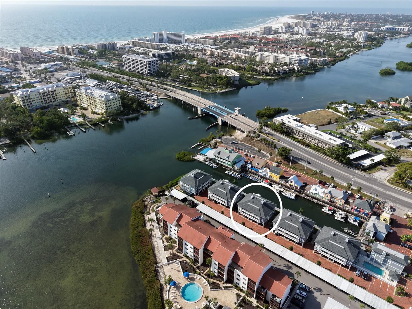 The Boatyard is a New England styled gated community of twenty one units located on the Intracoastal Waterway just across the south bridge from Siesta Key and its number one rated beach. Nearby are numerous opportunities for the shopping, dining, sports, and cultural activites that Sarasota is famous for. This furnished two bedroom, two bath unit feaures water views from most rooms, a bright open concept living/dining room with a tray ceiling, a wood burning fireplace, an enclosed balcony overlooking the water, updated kitchen and bathrooms,  an oversized one car garage, a bonus room on the canal, and a 27 foot boat slip.In addition, the community amenities include a sundeck on the bay, a boardwalk along the canal, and a heated swimming pool. This is the Florida lifestyle you've been looking for.