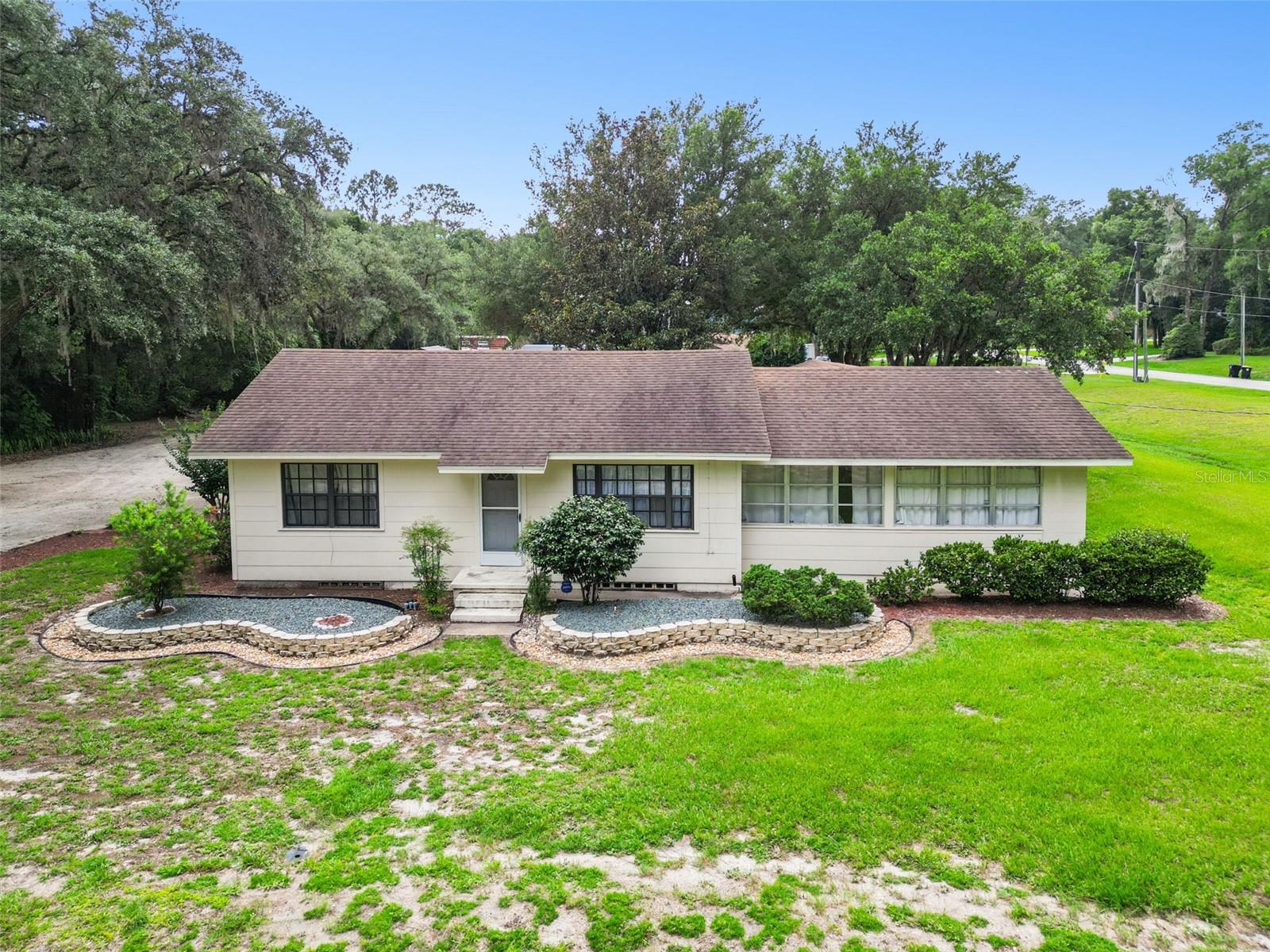 Welcome to this charming 4-bedroom, 2-bathroom home situated on a spacious and private 0.59-acre lot in the heart of Orange City! Offering plenty of room both inside and out, this property features a separate living room, a dedicated laundry room, and an abundance of storage closets throughout the home. Step outside and enjoy the beautifully landscaped yard, enclosed porch, and covered carport, perfect for parking, entertaining, or simply relaxing on the porch swing while enjoying the peaceful surroundings. Need extra space for hobbies, projects, or storage? The impressive 720-square-foot workshop provides endless possibilities. With no HOA restrictions, you'll have the freedom to truly make this property your own. Conveniently located near shopping, dining, and everyday amenities, this home also offers easy access to I-4, making travel to Orlando attractions a breeze. Enjoy being just minutes from the area's natural beauty, including rivers, beaches, historic downtown DeLand, and popular state parks and springs such as Blue Spring State Park. Whether you're looking for space, privacy, or a versatile property with room to grow, this Orange City gem is one you won't want to miss!
