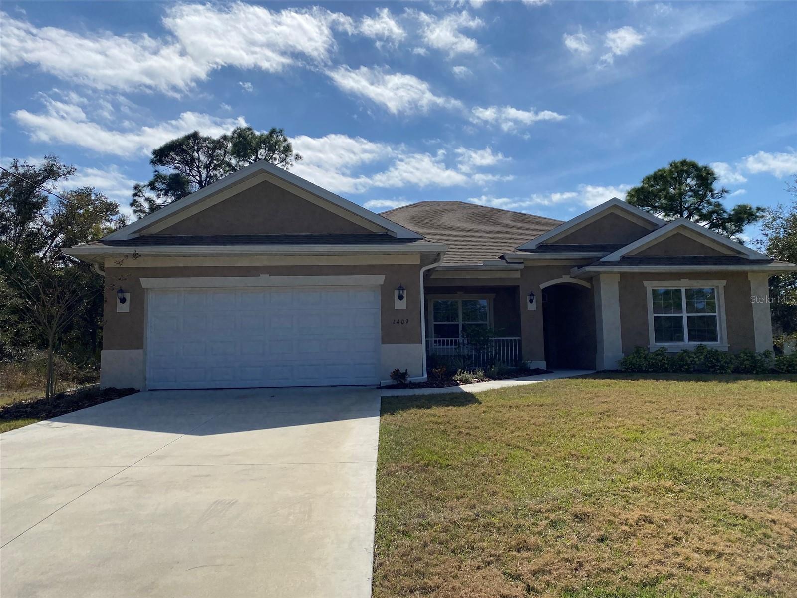 PRICE REDUCED!! New construction. Move in ready. This 3 bedroom home has spacious rooms with an open/split floor plan. 9'4" ceilings. Kitchen has a granite countertop. Breakfast bar which compliments the kitchen. The great room is in combination with the kitchen as an open concept. There are French doors from the great room and dining room which leads to a covered porch. The split bedroom plan has a primary bedroom which features a walk in closet, walk in shower, double sinks and a garden bathtub. The home has a separate laundry room with  cabinet space situated between the kitchen and 2 car garage.