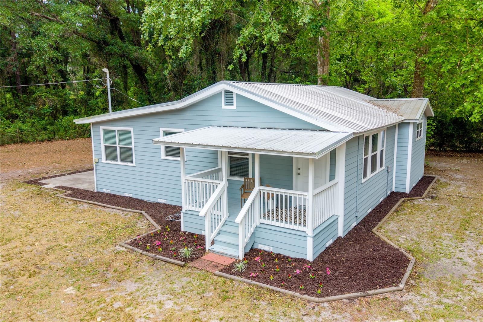 Escape to your own private slice of High Springs! Situated on nearly half an acre beneath a canopy of mature trees, this beautifully remodeled 2-bedroom, 2-bath home offers the perfect blend of comfort, charm, and natural beauty. Step inside to discover bright, inviting living spaces highlighted by vaulted ceilings and thoughtful updates throughout. Whether you're looking for a peaceful primary residence, a weekend getaway, or an income-producing investment, this property delivers exceptional flexibility. Currently operating as a short-term rental, it is ideally positioned just minutes from High Springs' charming downtown, crystal-clear springs, scenic rivers, and endless outdoor adventures. Enjoy the tranquility of country-style living with the convenience of nearby amenities.