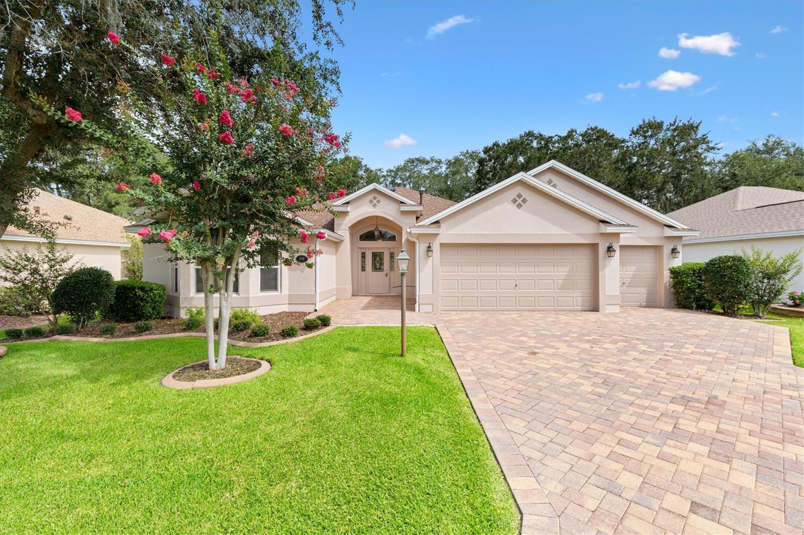 Experience golf-course living at its finest at 1649 Hartsville Trail in Sunset Pointe, The Villages - a Lantana model showcasing unobstructed panoramic views of the Heron Golf Course and mature tree lines.  Total privacy - you will never see a neighboring home behind this property.  This elegant 3-bed, 2-bath residence (2021 sq ft) welcomes you with a leaded-glass front door, soaring ceilings, double crown molding and abundant natural light through double-paned windows.  The open-plan kitchen boasts granite counters, tile backsplash, breakfast bar, gas range, stainless steel appliances, Samsung refrigerator, new microwave, and a pantry with slide-out shelves.  Enjoy seamless indoor-outdoor living via large sliders from the main living area to a screened lanai overlooking the fairway.  The owner's suite is a serene retreat with walk-in shower, walk-in closet, water closet, and stone counters.  Practical luxury includes a 2-car garage plus golf cart bay, both with electric openers, and pull-down stairs to finished attic storage.  Inside Laundry room includes Maytag washer and dryer, cabinets, and a wall ironing board.  New Roof and Fresh interior and exterior paint in 2026.  3.5-Ton Lennox AC w thermostat (2022).  NO BOND!!  This home is move-in ready for relaxed maintenance-free Village living.  Main Living Area and Master Bedroom have been virtually staged.