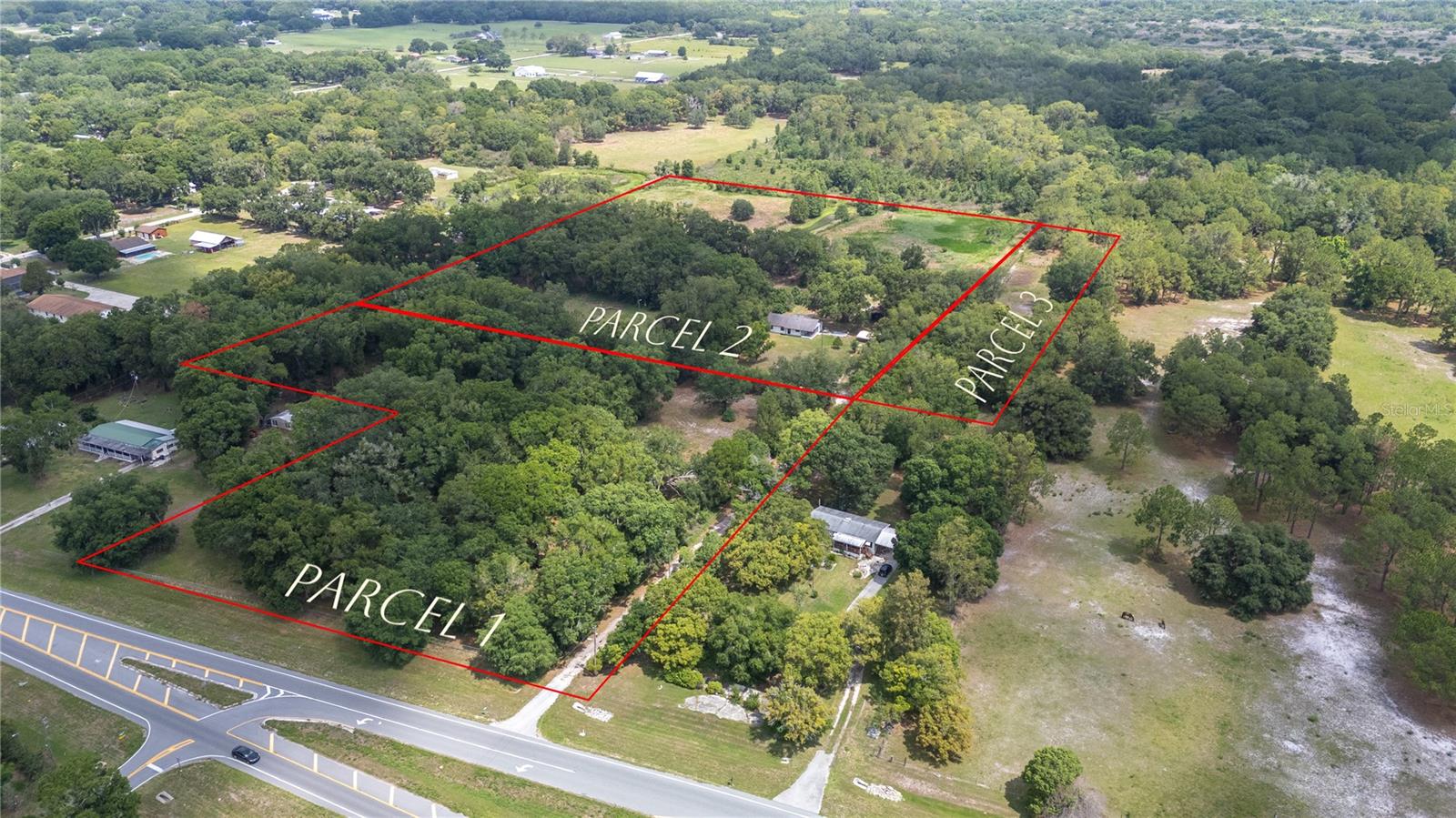 Virtually Staged. Discover the perfect blend of privacy, functionality, and rural charm with this exceptional 20.29-acre property, featuring three parcels (2008, 1994, and 0 Old Dixie Hwy, Auburndale, FL). With approximately 70% of the land high and dry, this fenced property is ready for livestock, farming, recreational vehicles, or anyone seeking the tranquility of true country living.

Tucked away at the end of a quiet rural road, this peaceful retreat offers the seclusion you've been searching for while providing endless opportunities for a homestead, hobby farm, family compound, or private getaway.

The well-maintained 1,710-square-foot home features 3 bedrooms and 2 full bathrooms with a spacious, open-concept family and dining area that's perfect for gathering with family and friends. Nearly 80% of the home showcases attractive wood-look tile flooring, complemented by new carpet and luxury vinyl plank flooring in the bedrooms for added comfort.

The inviting kitchen is equipped with stainless steel appliances, charming retro-style cabinetry, a convenient breakfast bar, and abundant storage space. Large windows and inviting outdoor living spaces allow you to fully appreciate the peaceful surroundings and the abundant wildlife that make this property so special.

Step outside to enjoy two oversized covered porches, ideal for entertaining, relaxing, or taking in the beautiful country views. The large barn offers excellent potential as a workshop, equipment storage, or livestock facility.

Adding even more versatility, the property includes a large concrete RV pad complete with electricity and septic service. A third well and septic system are already in place, providing the opportunity to add another residence if desired. In total, the property boasts 3 wells and 3 septic systems, making it uniquely equipped for future expansion or multi-generational living.

Major updates provide added peace of mind, including a 2018 roof, 2018 electrical panel, new hot water heater and 2022 A/C system.

With potential for a private land bank option, this remarkable property offers flexibility, value, and limitless possibilities. Whether you're looking to create your dream farm, establish a private family retreat, or simply enjoy the beauty of country living, this one-of-a-kind property is ready to welcome you home.

Virtually staged.