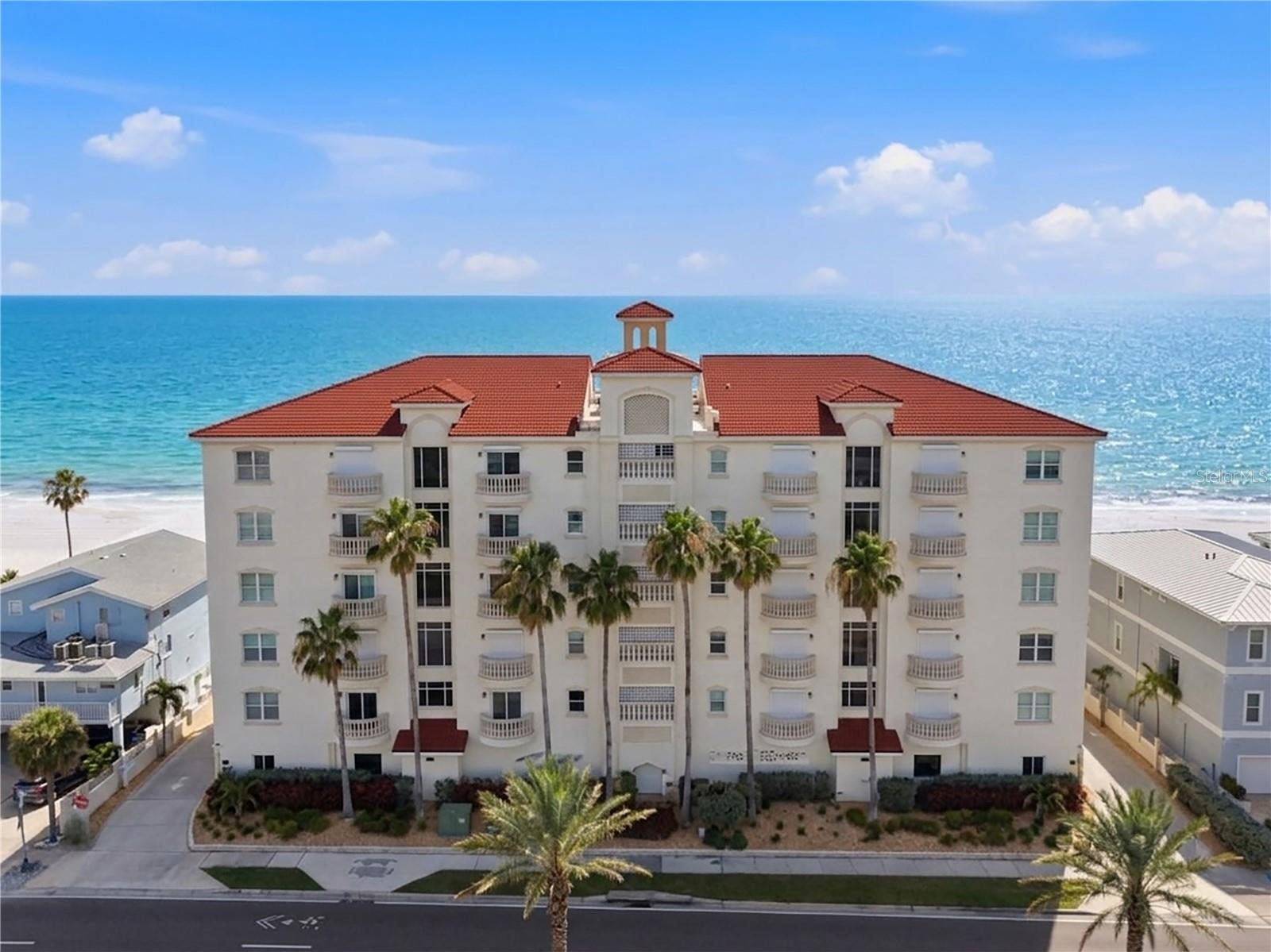 Experience elevated coastal living along the pristine beaches of the Gulf of Mexico. From the moment your private elevator opens, you’re welcomed by breathtaking, unobstructed water views that stretch across nearly every room, setting the tone for a truly exceptional coastal retreat.

Seamless indoor-outdoor living takes center stage as sliding glass doors open to an expansive wraparound balcony—nearly 100 feet of frontage—where you can unwind to the sound of the waves, take in unforgettable sunsets, and entertain against a stunning Gulf backdrop.

The chef’s kitchen is both refined and functional, featuring solid surface countertops, a designer tile backsplash, shaker-style cabinetry with glass accents, and a full suite of stainless steel appliances, including a double convection oven and gas range. A substantial center island with generous seating anchors the space, making it ideal for hosting.

The primary suite is a true sanctuary, complete with a spacious bedroom, private sitting area or office, and a spa-inspired bath featuring dual vanities, an oversized walk-in shower, and a soaking tub designed for relaxation. The custom walk-in closet is outfitted with built-ins and a center island, delivering both style and functionality.

Two additional bedrooms feature en-suite baths, while a fourth bedroom is conveniently positioned near a full bath accessible from the main living areas—ideal for guests.

Thoughtfully enhanced, the residence includes a Marantz integrated audio system for a seamless, high-quality sound experience throughout, remote-operated hurricane shutters that can be secured with the touch of a switch, and recent HVAC updates in 2024 and 2025, offering added comfort and peace of mind—all contributing to a home designed for effortless coastal living.

Verandas on the Gulf is an exclusive, boutique-style building with only 10 residences, offering a heightened sense of privacy and security. Amenities include a beautifully maintained heated pool and spa, a clubhouse with kitchenette and restrooms, covered guest parking, and private double garages for each residence.