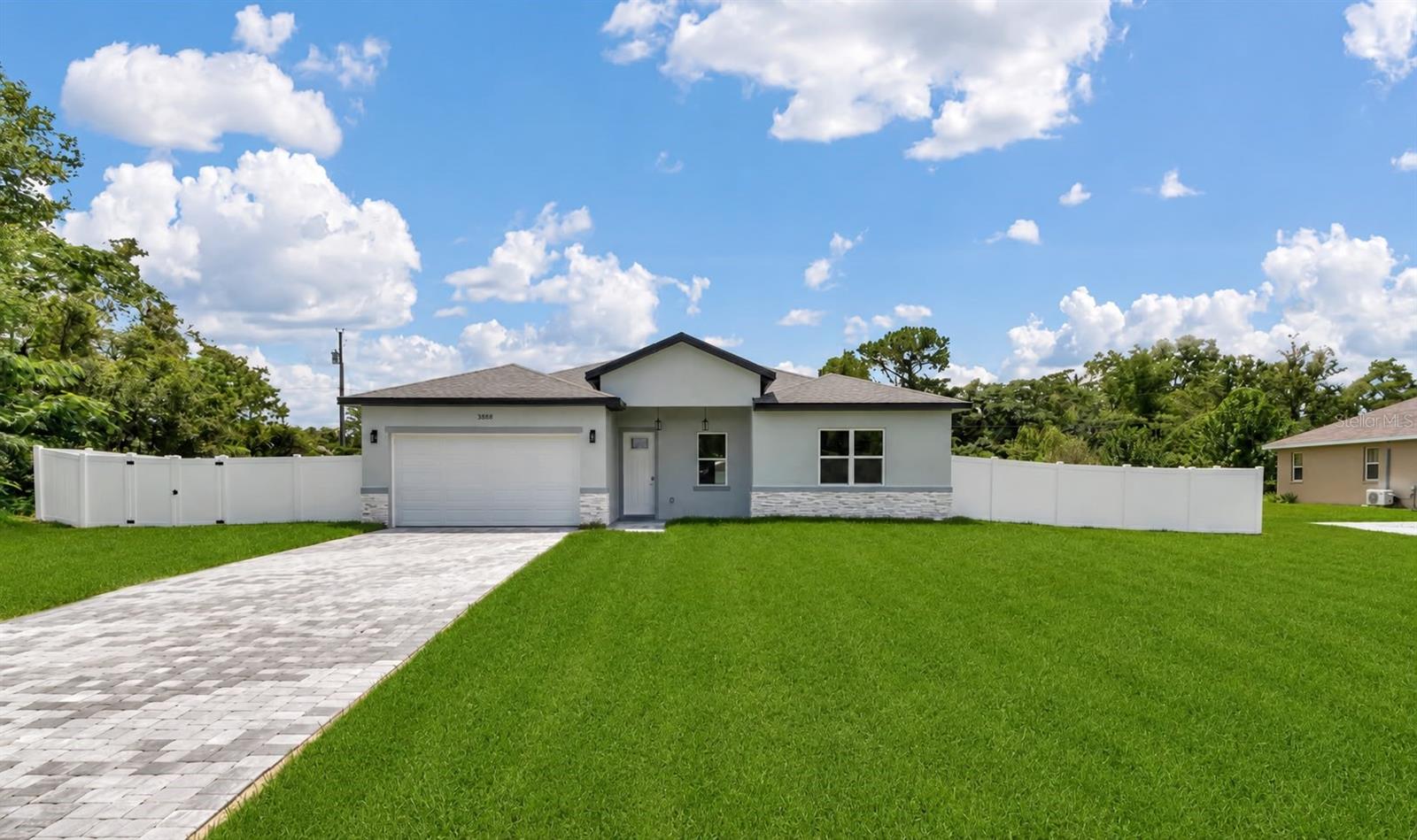 Beautiful new construction home on an oversized lot with a fully fenced backyard.

Discover the perfect blend of modern design, comfort, and convenience in this stunning new construction home located in desirable Ocala. Offering 4 spacious bedrooms, 2 full bathrooms, and 1 half bathroom, this thoughtfully designed residence provides plenty of space for both everyday living and entertaining.

Step inside to an inviting open-concept floor plan featuring expansive living and dining areas filled with natural light, creating the perfect setting for gathering with family and friends. The beautifully designed kitchen serves as the heart of the home, showcasing solid wood cabinetry, elegant stone countertops, and a full suite of included appliances, combining style and functionality for any home chef.

The private primary suite offers a relaxing retreat with a generous walk-in closet and a well-appointed en-suite bathroom. The additional bedrooms are comfortably sized and feature built-in closets, providing excellent storage and versatility for family members, guests, or a home office.

Step outside and enjoy the added value of the brand-new fenced yard, offering a rare combination of privacy and peace of mind. Whether you're hosting outdoor gatherings, creating a play area, or simply enjoying your own private outdoor retreat, this fully enclosed backyard provides endless possibilities.

Additional highlights include an attached 2-car garage, modern finishes throughout, and quality craftsmanship that makes this home truly move-in ready.

Conveniently located near a major roadway for easy commuting and close to highly rated schools, shopping, dining, and everyday amenities, this exceptional property offers the lifestyle you've been searching for. Don't miss the opportunity to make this beautiful new home yours today.