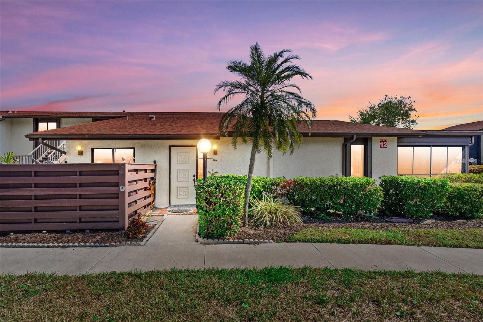 Welcome to Morton Village, a well-established 55+ community offering low-maintenance Florida living in a highly convenient Bradenton location. This ground-floor condominium provides comfort, accessibility, and peace of mind with no upstairs neighbors and a thoughtfully designed layout.

The residence features cathedral ceilings, spacious living areas, and has been freshly painted with new luxury vinyl flooring throughout. The bathroom includes a walk-in shower with support bars, enhancing ease of use. A new water heater (2025) adds recent system value, and the unit is partially furnished, allowing for an easy transition whether used as a primary residence or seasonal home.

A standout feature is the expansive enclosed lanai, offering flexible bonus space ideal for a sitting area, hobby room, home office, or den. An assigned carport is included for convenient covered parking.

Morton Village provides carefree, maintenance-free living, with the monthly association fee covering water, sewer, trash, cable, internet, and exterior maintenance, simplifying monthly expenses. Community amenities include two swimming pools, a clubhouse, and an active social calendar, creating opportunities for both relaxation and connection.

Major recent updates include a new community roof (2022). The location places you minutes from Anna Maria Island, Downtown Bradenton, Downtown Sarasota, dining, shopping, and medical facilities, with easy access to Sarasota-Bradenton International Airport.

This move-in-ready condominium is well-suited for full-time residency or seasonal enjoyment, offering comfort, convenience, and a relaxed Florida lifestyle in a desirable 55+ setting.

Schedule your private showing today and explore the ease of living at Morton Village.